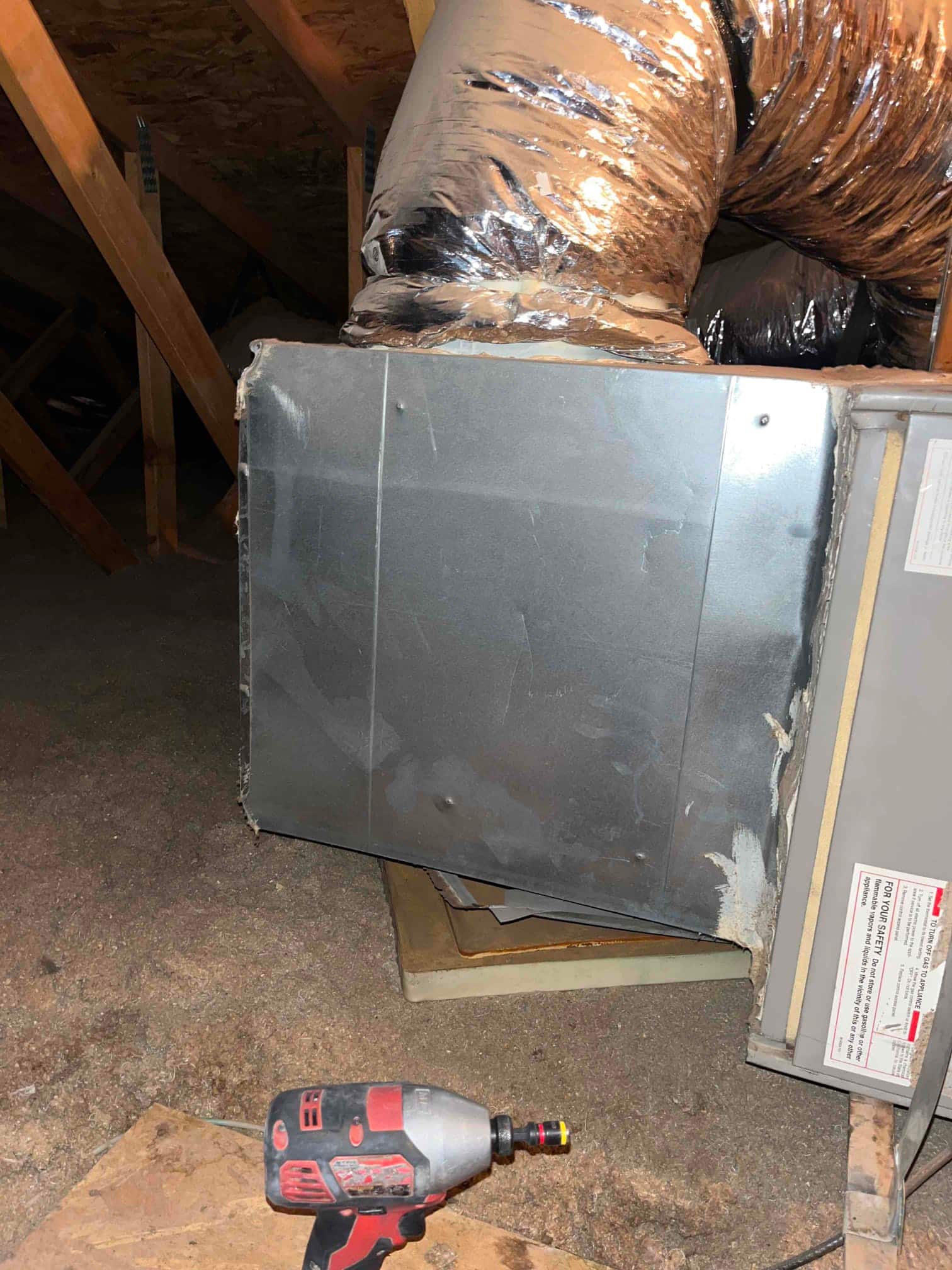 Attic air handler with metal supply plenum and insulated flex duct connection, mastic applied at seams.