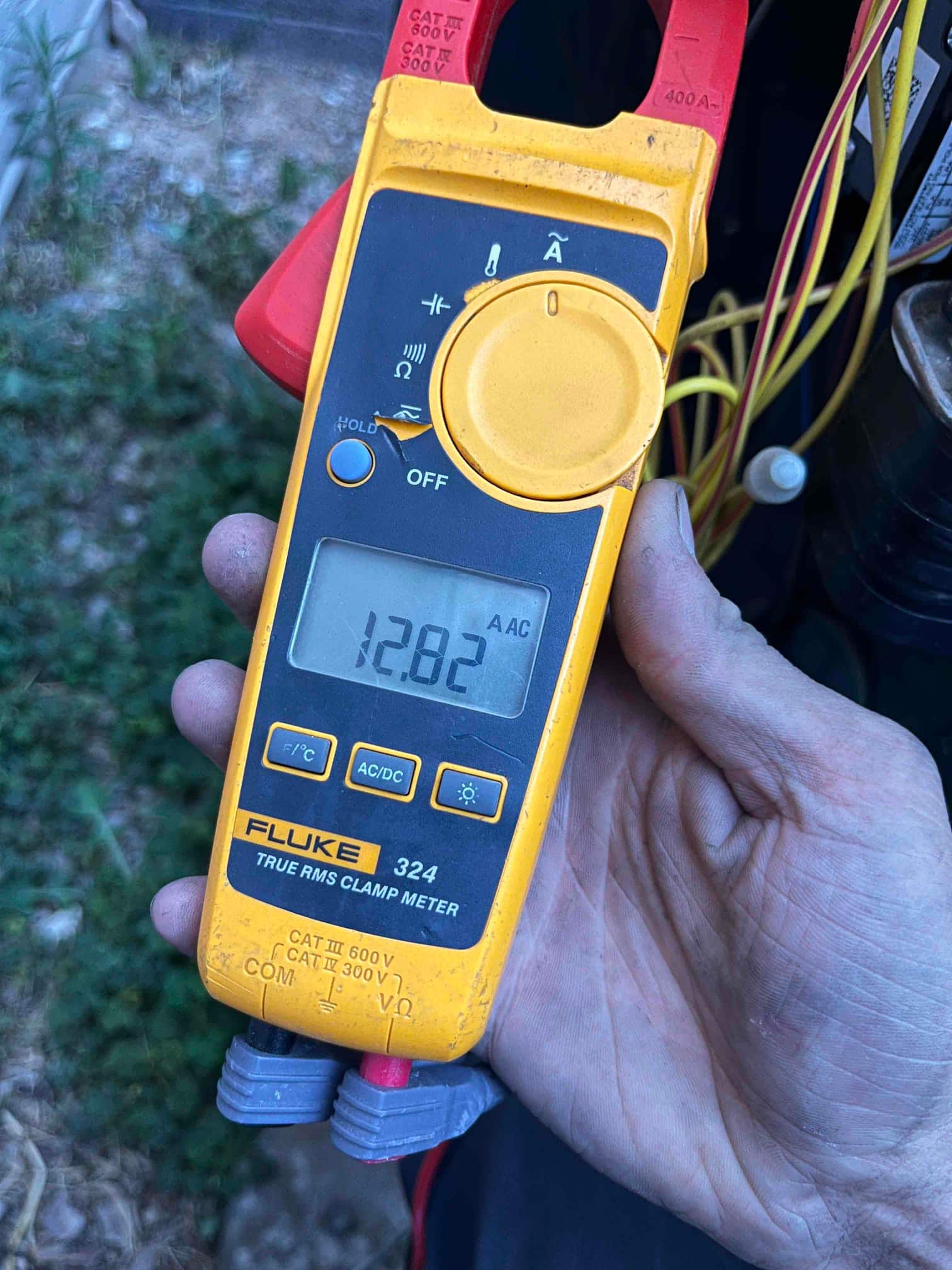 Diagnostic instrument display shows 12.82 A.