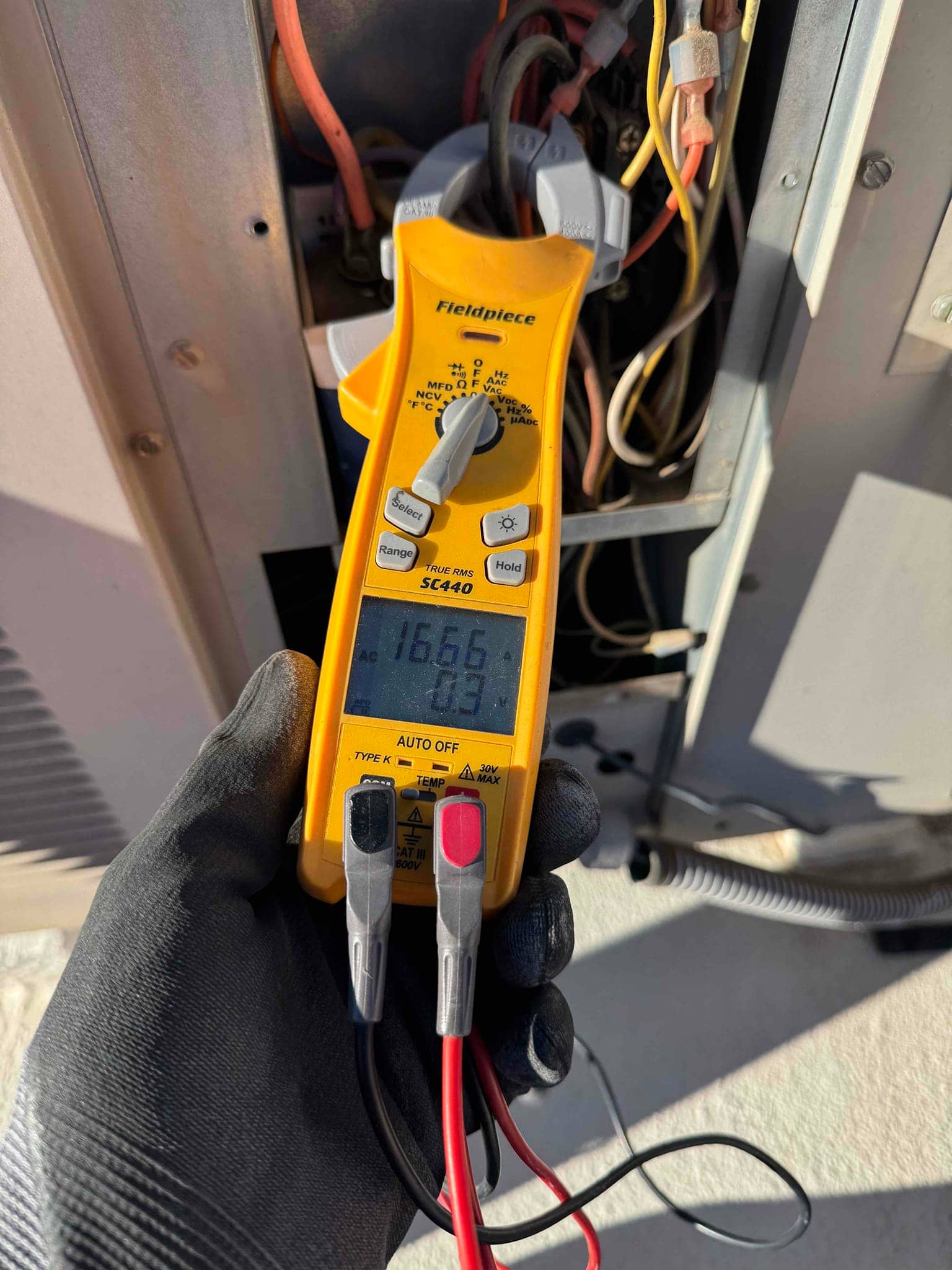 HVAC diagnostic instrument photographed during the service visit.