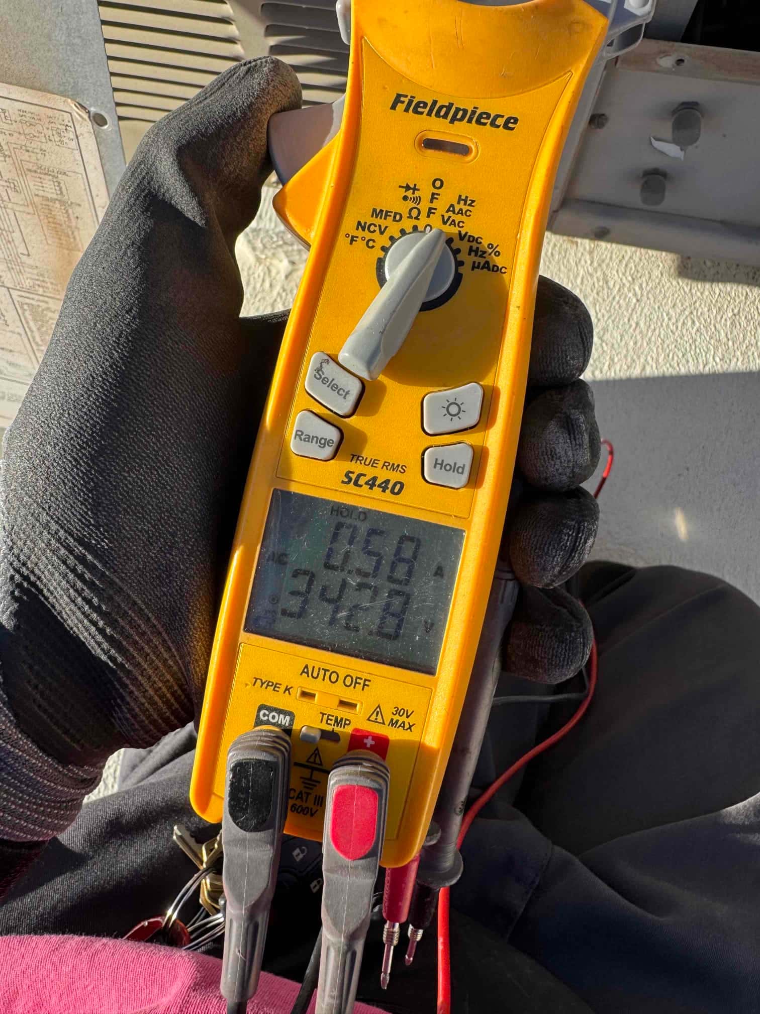 HVAC diagnostic instrument photographed during the service visit.