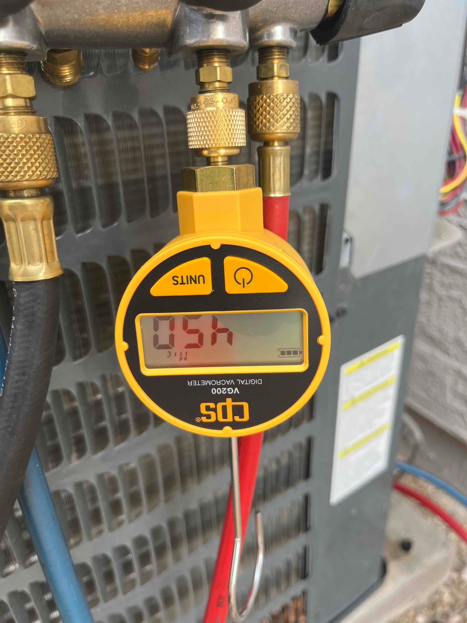 HVAC diagnostic instrument photographed during the service visit.