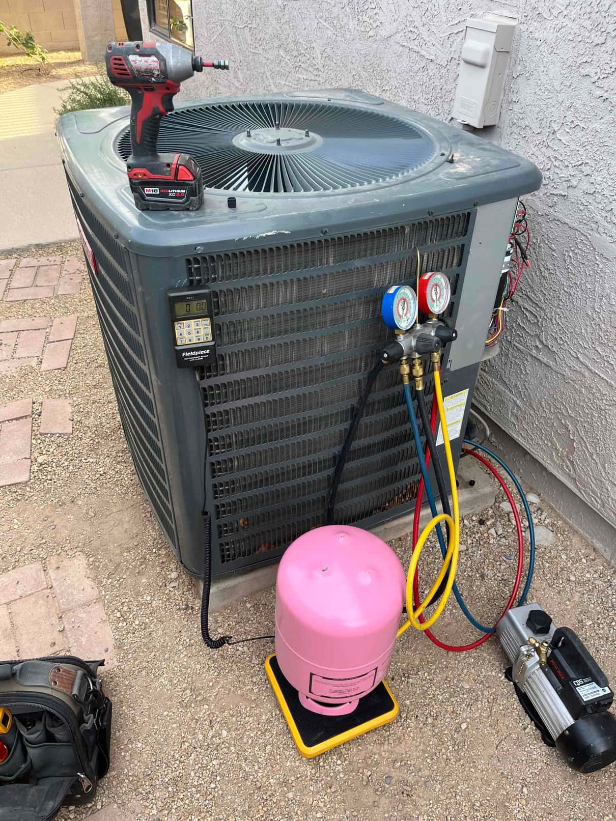 Refrigerant scale photographed during the service visit; no numerical reading is transcribed.