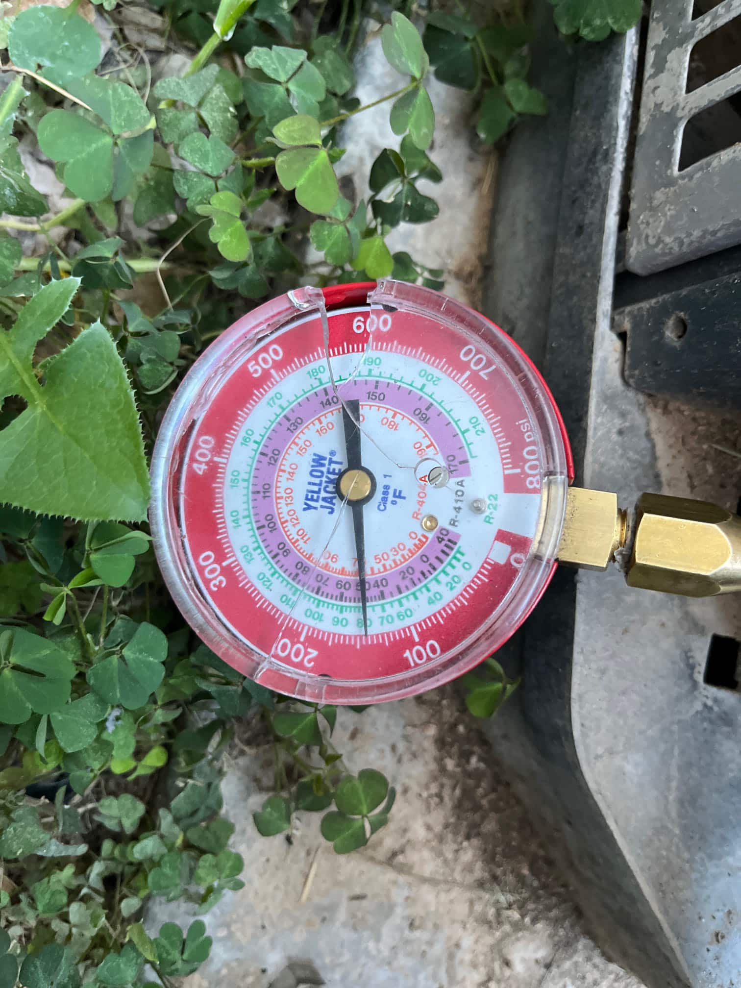 Refrigerant scale photographed during the service visit; no numerical reading is transcribed.