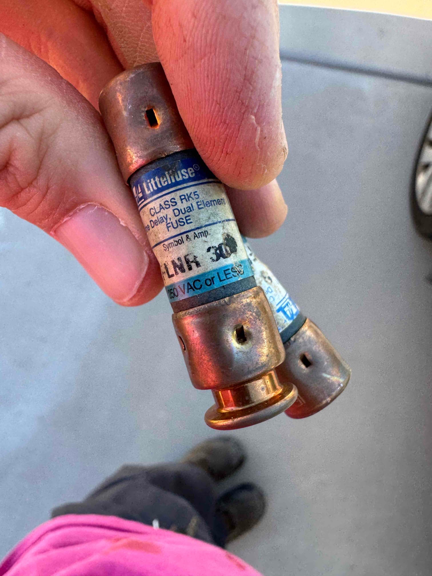 Time-delay dual-element fuse labeled LNR 30, 250 VAC or less, with worn metal end caps.