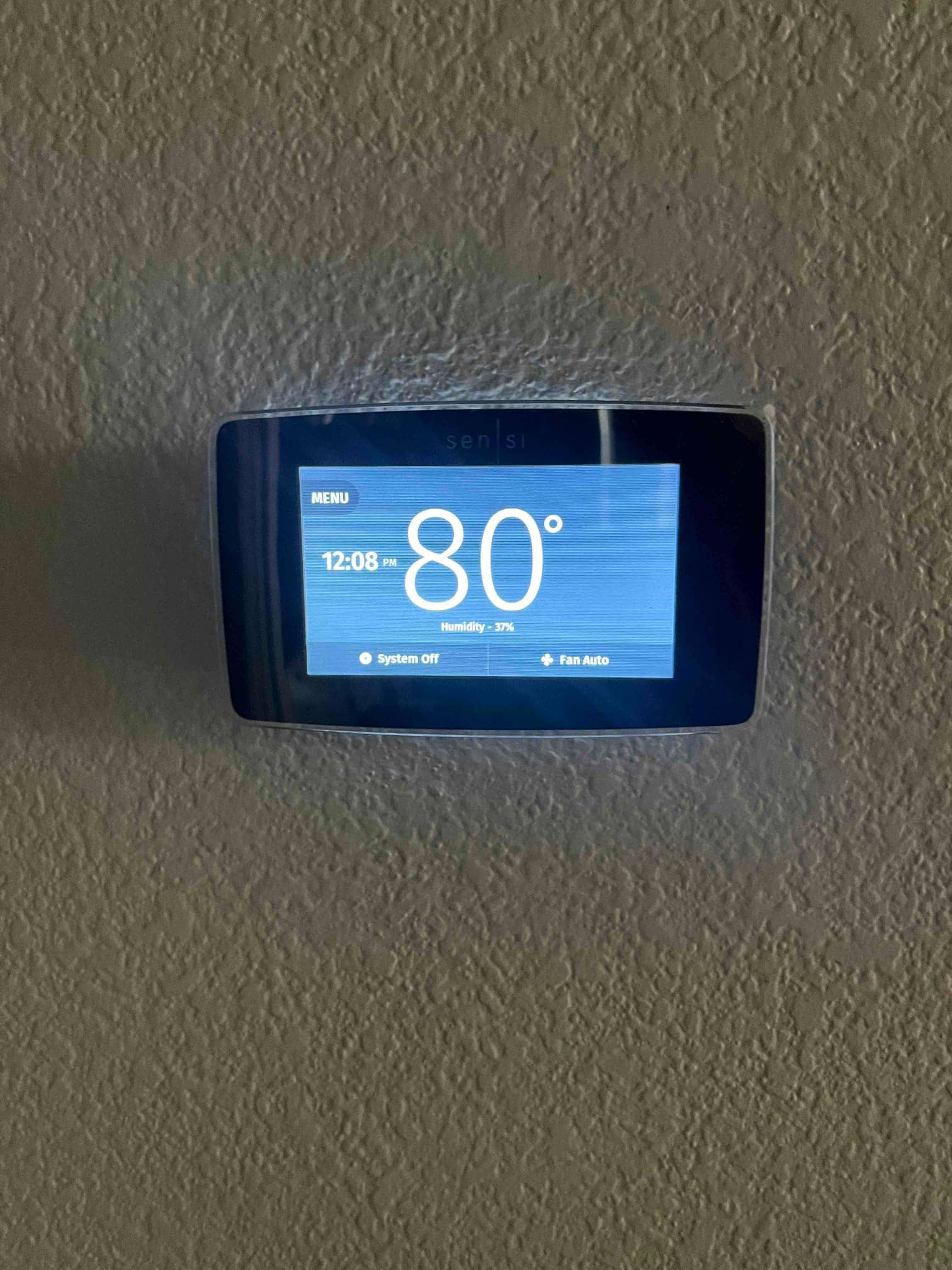 Wall-mounted digital thermostat displays 80° temperature and 37% humidity, with system off and fan set to auto.