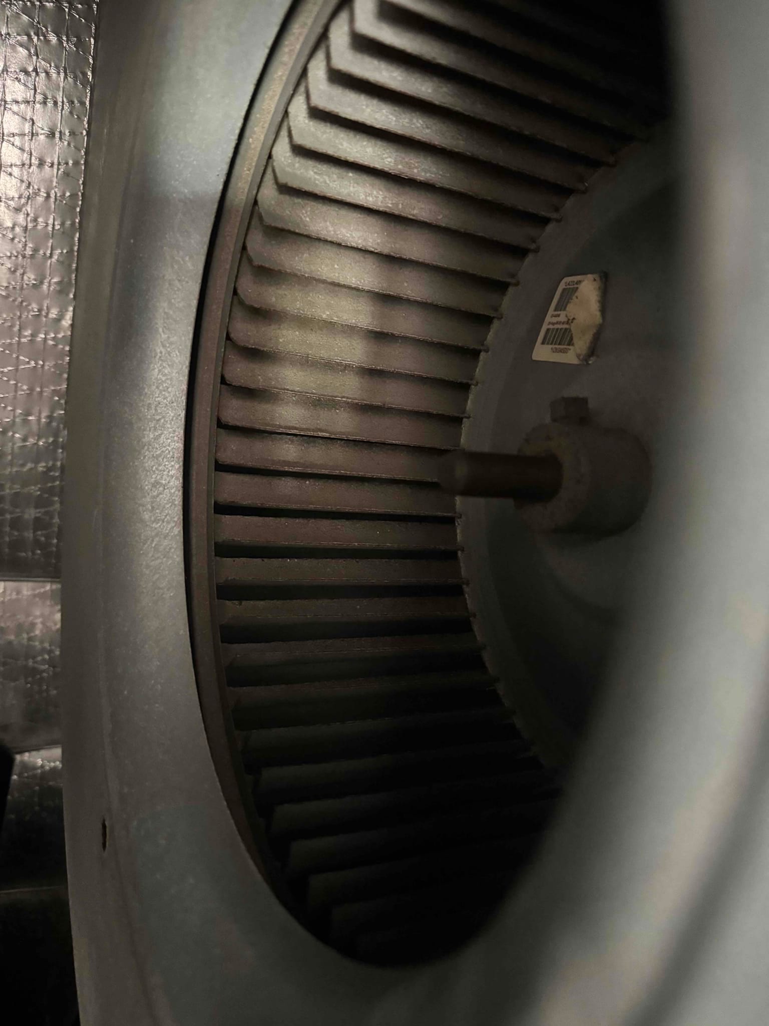 Centrifugal blower wheel inside the air handler housing, with visible fins and motor shaft.