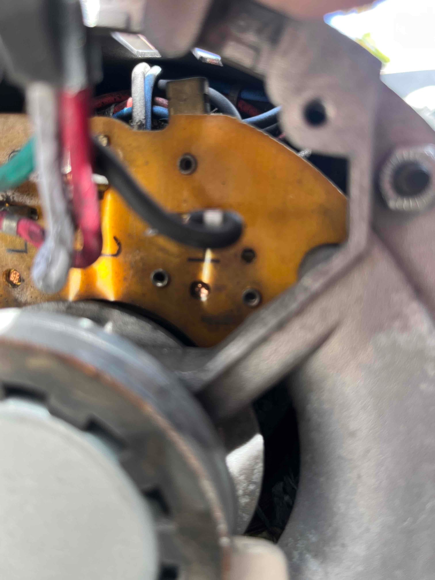 Close-up of an electric fan motor assembly showing the metal housing, attached fan blade, and connected wiring.
