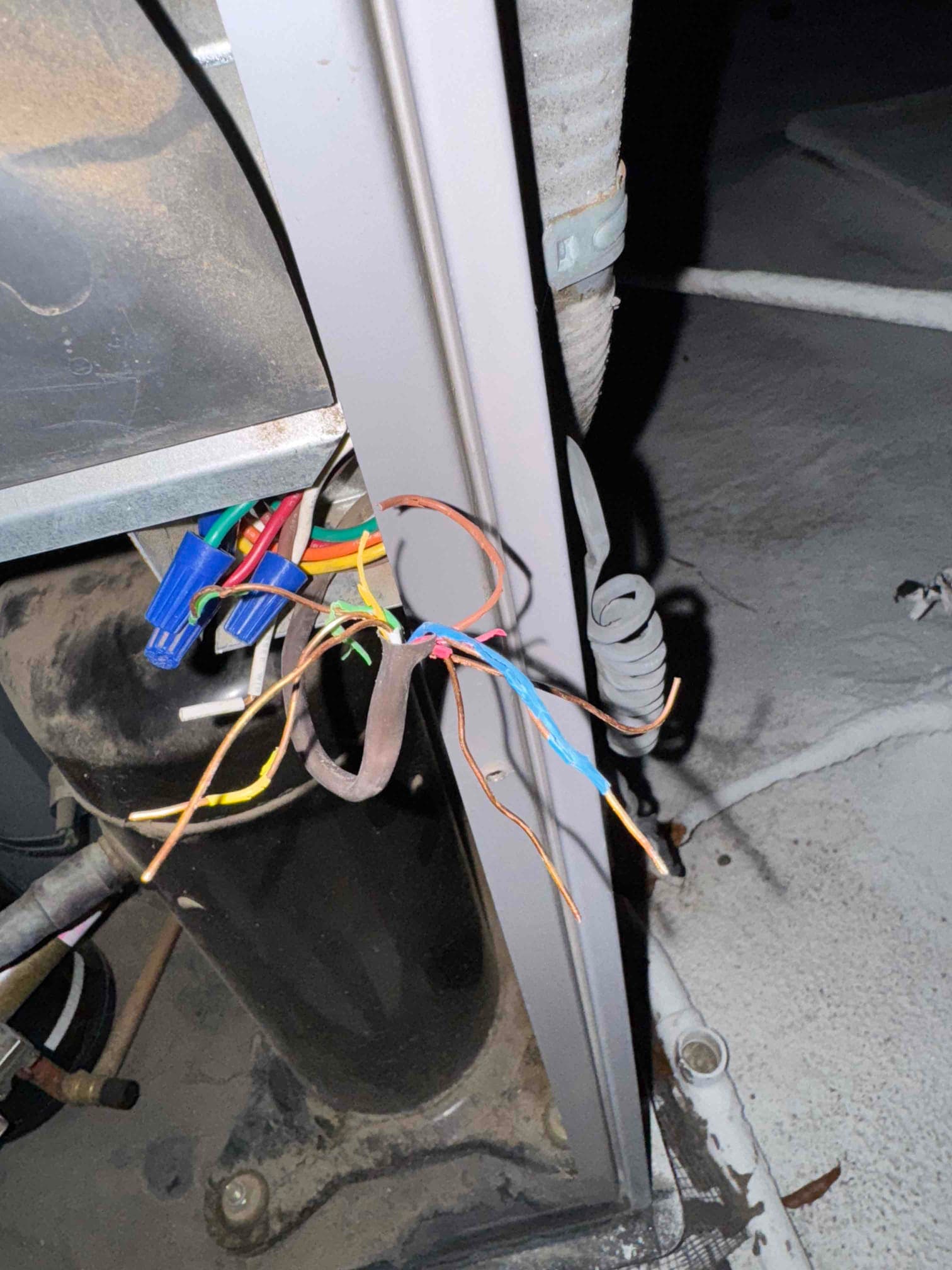 Condenser compartment shows the compressor and several loose, stripped wires with plastic wire connectors visible.