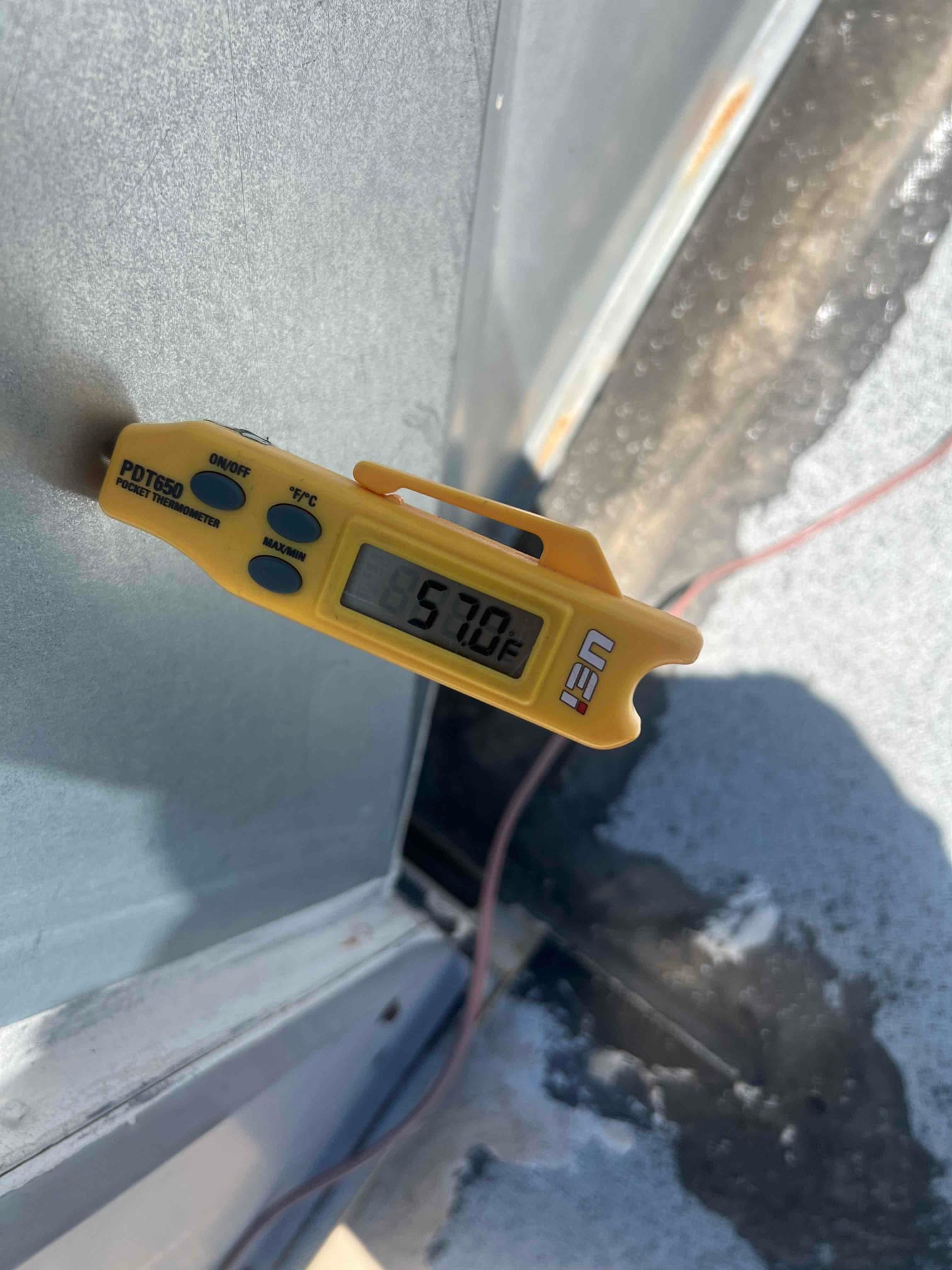 Diagnostic instrument display shows 57.9 °F.