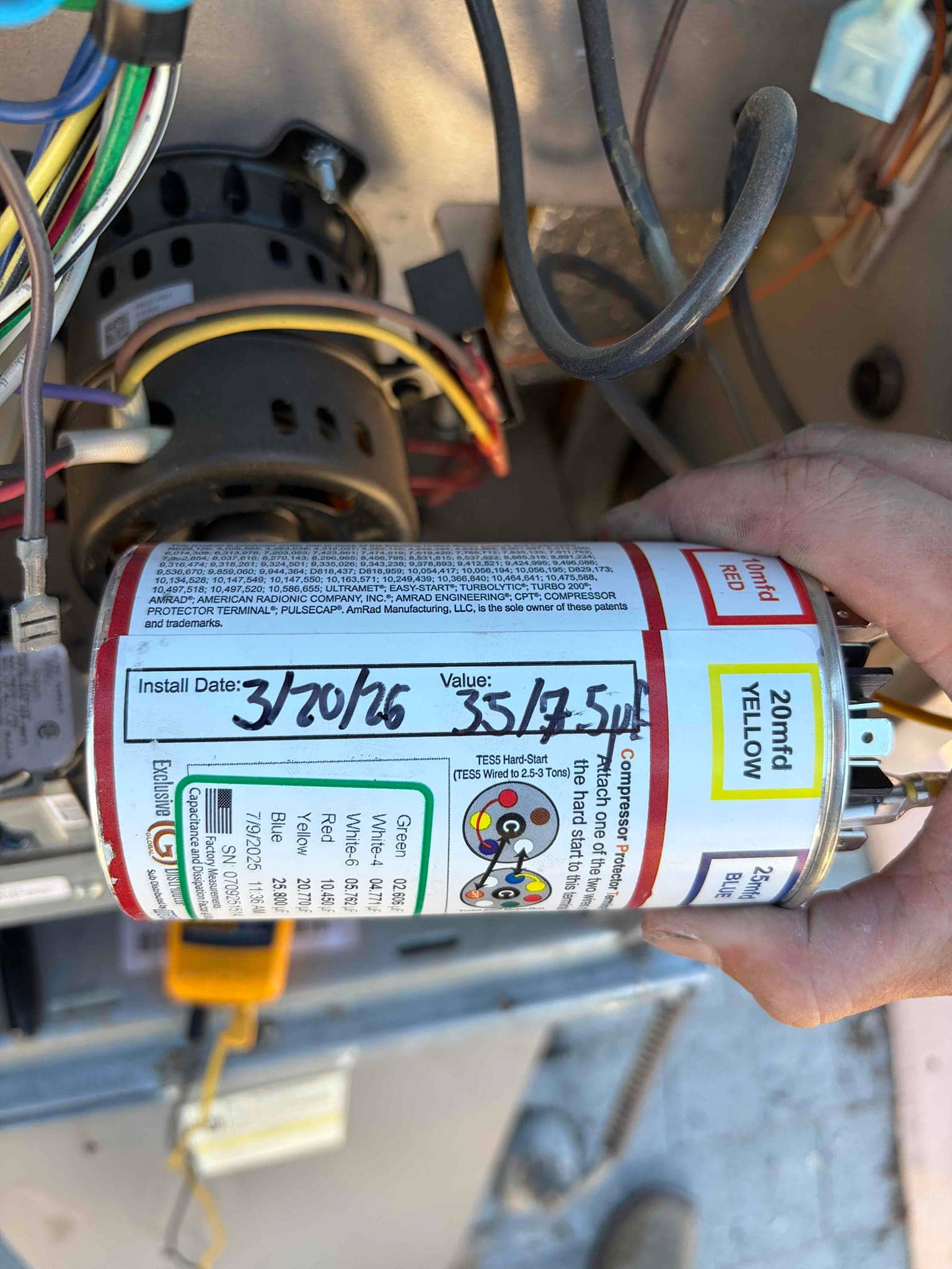 Dual-run capacitor labeled 35/7.5 μF with wiring terminals visible inside the condenser electrical compartment.