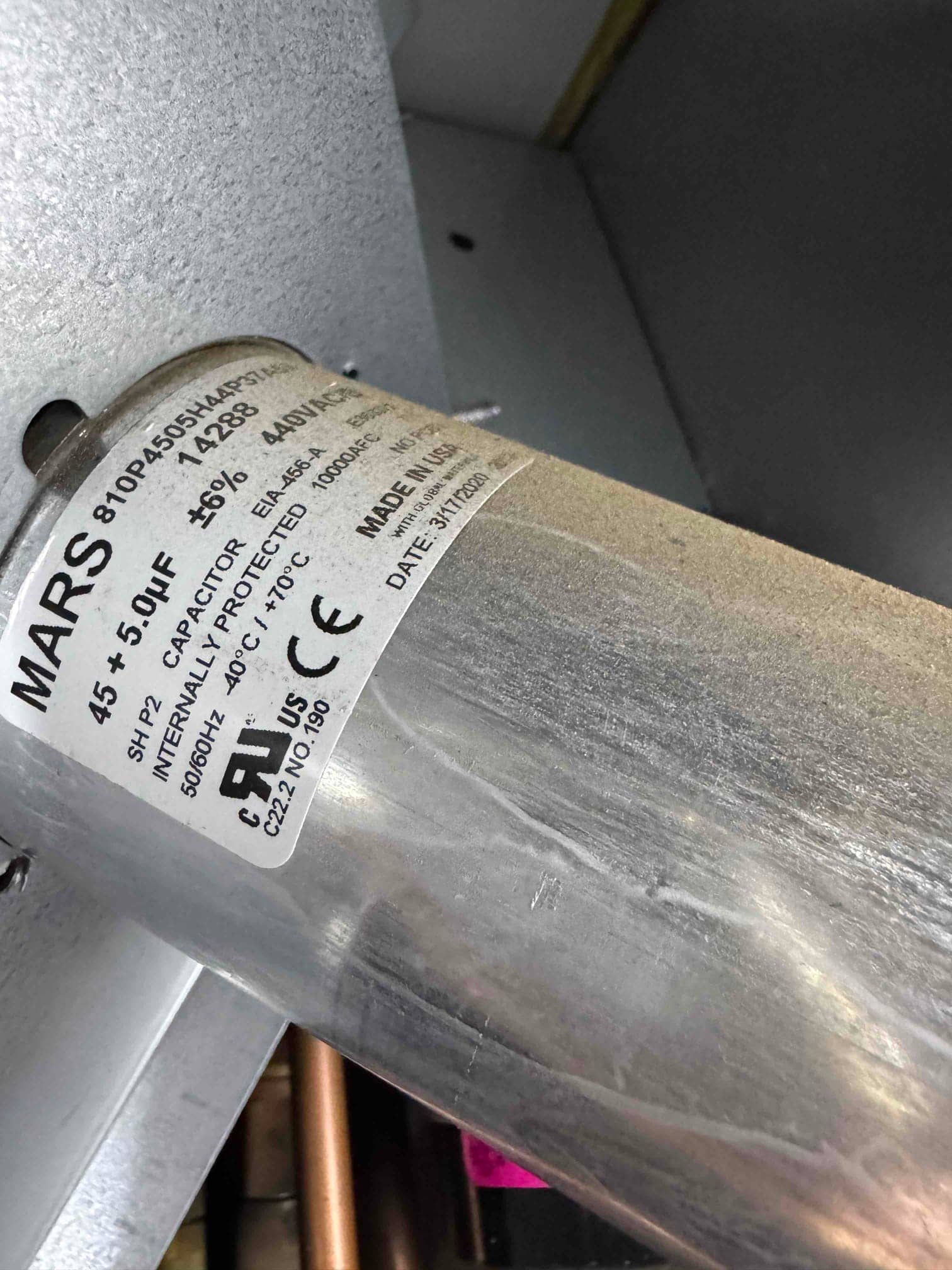 Dual-run capacitor labeled 45/5 μF, 440V AC, inside the HVAC equipment cabinet.