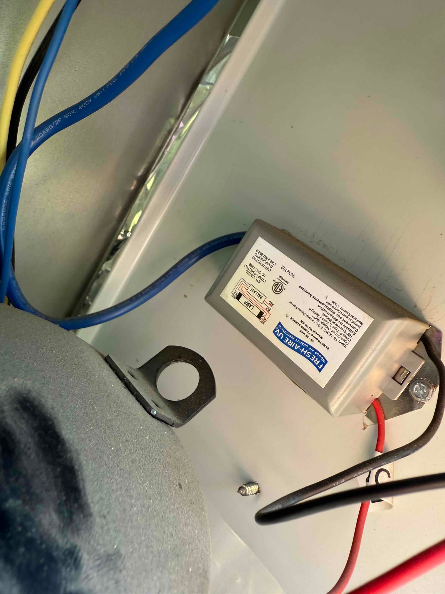 Hard-start kit mounted in the unit's electrical compartment with red and black leads routed to the circuit.