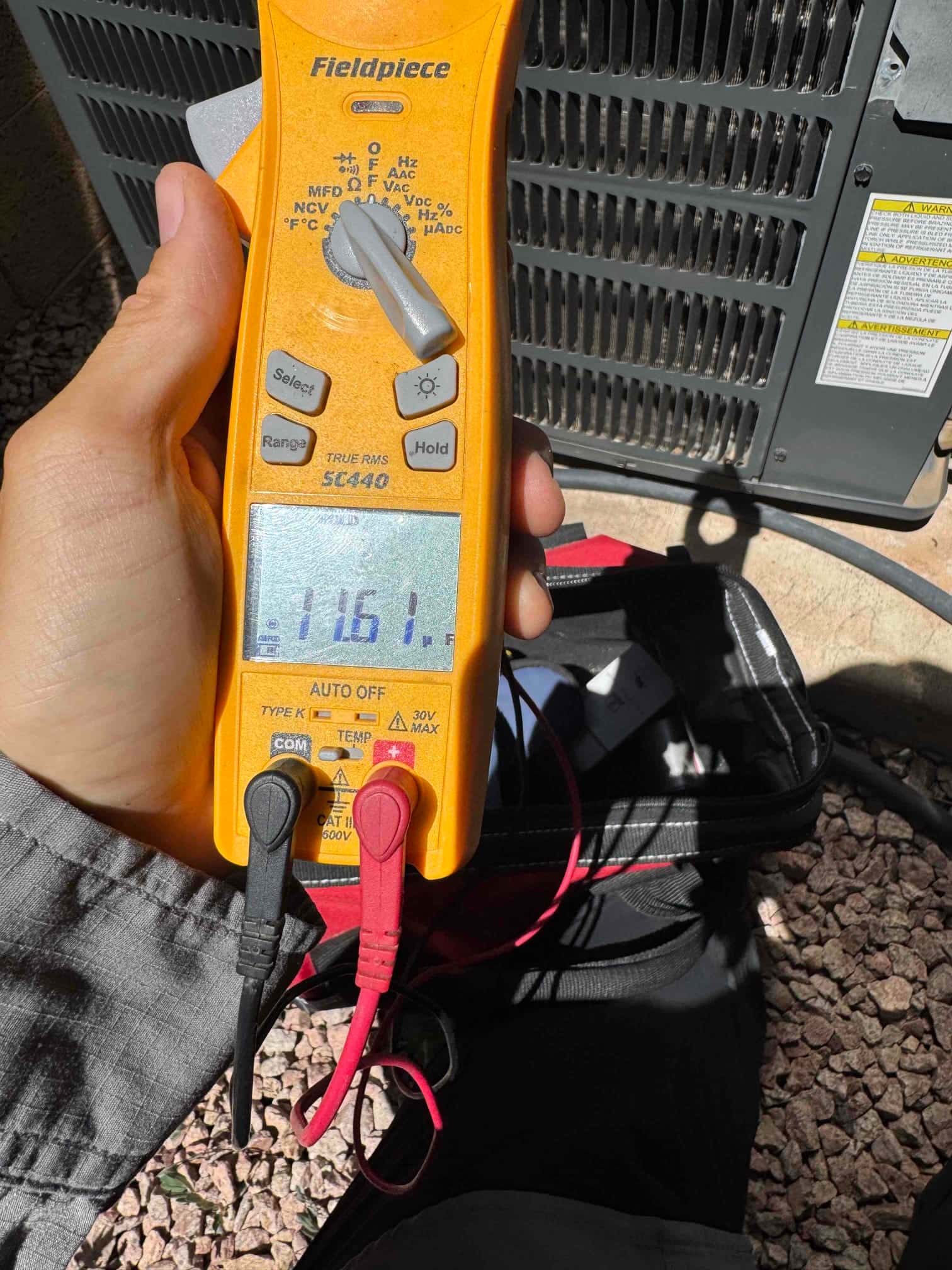 HVAC diagnostic instrument photographed during the service visit.
