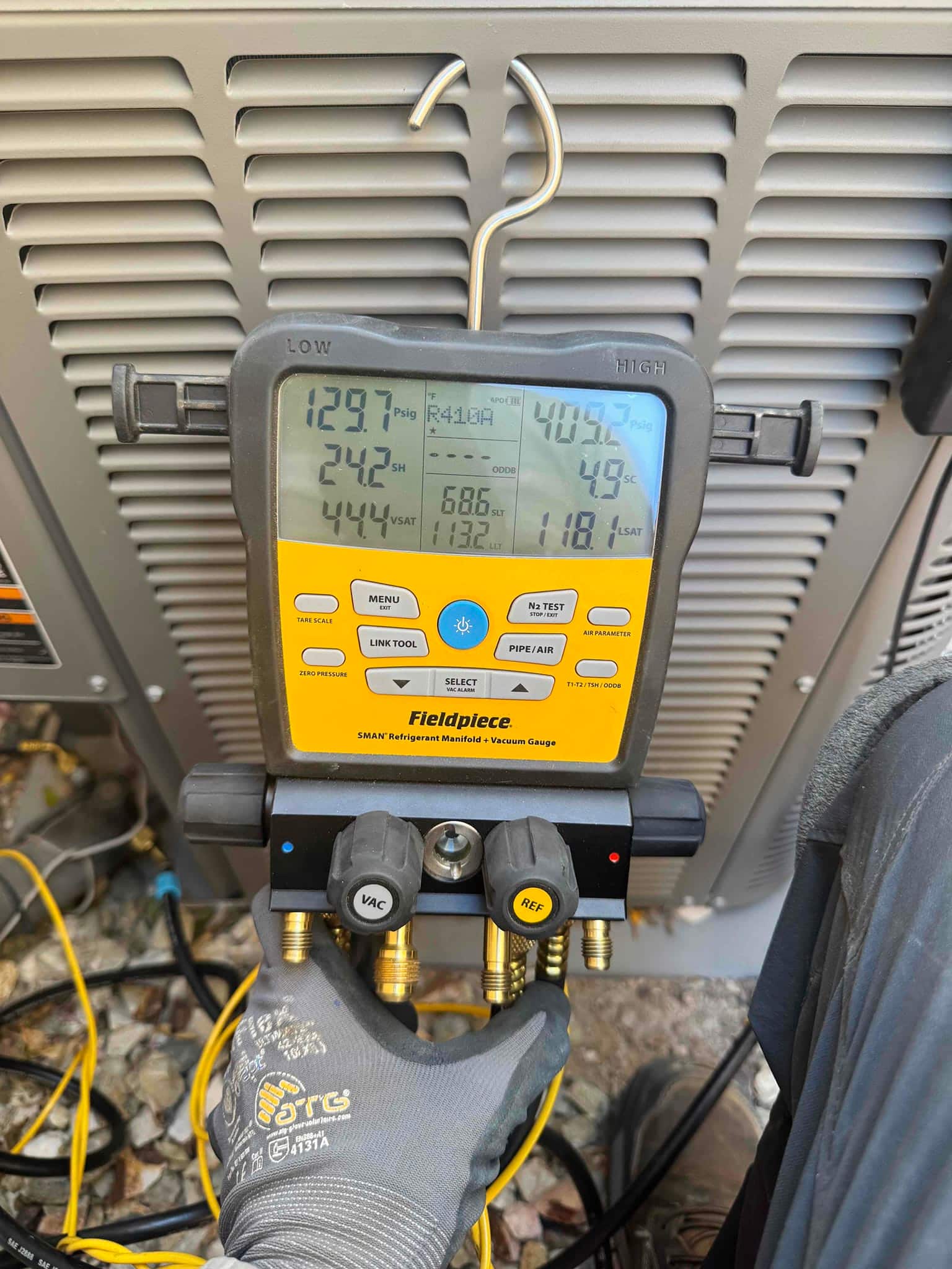 HVAC diagnostic instrument photographed during the service visit.