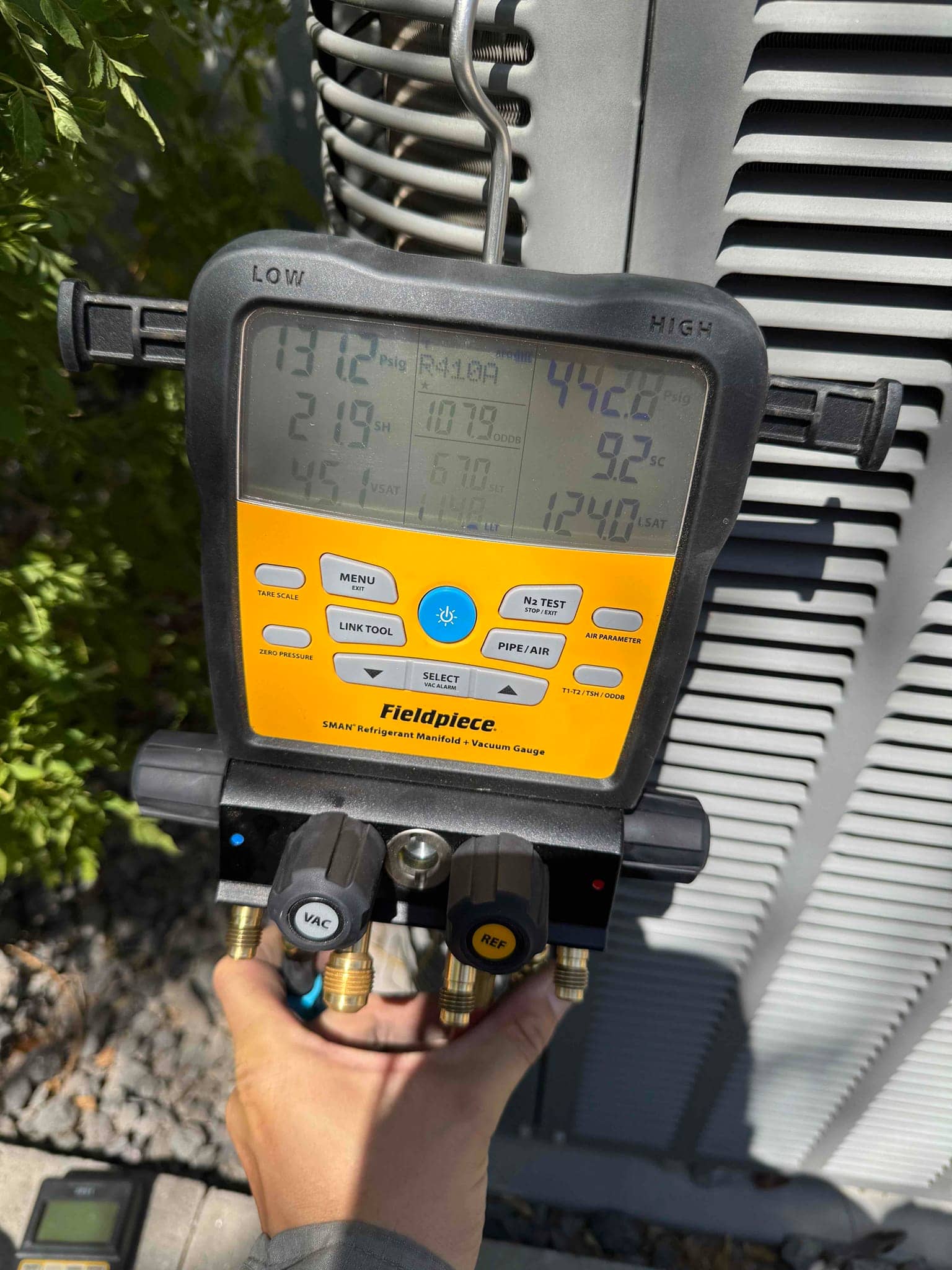 HVAC diagnostic instrument photographed during the service visit.
