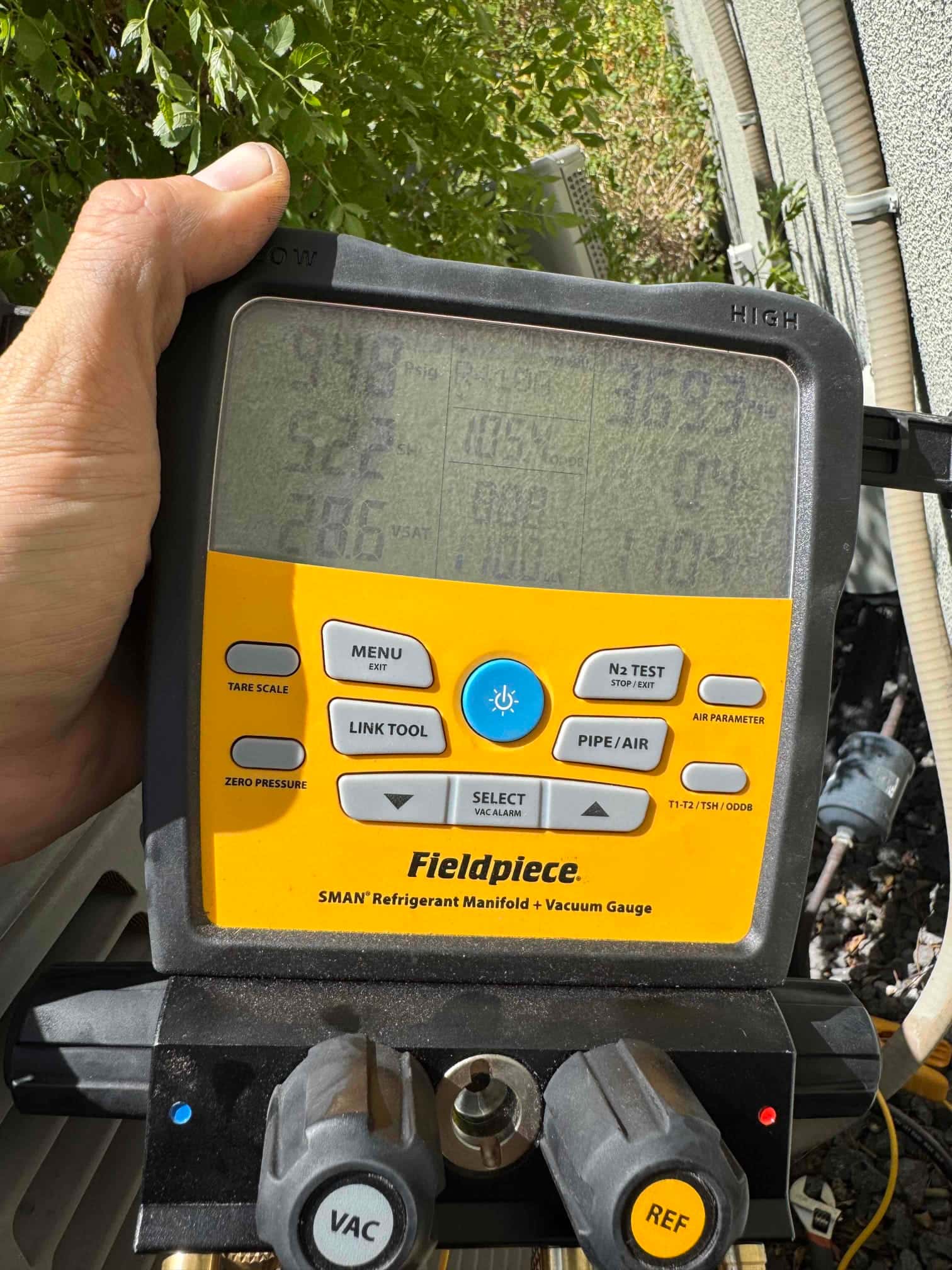 HVAC diagnostic instrument photographed during the service visit.