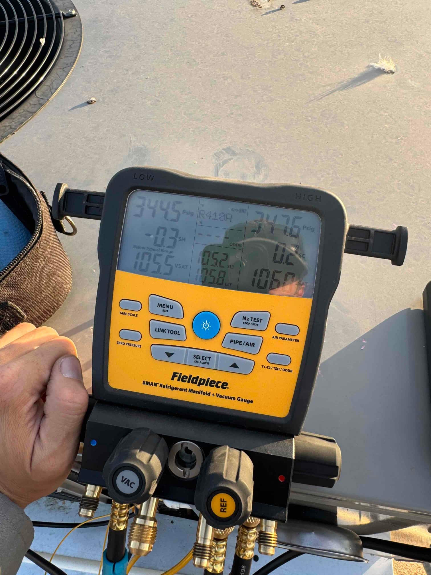 HVAC diagnostic instrument photographed during the service visit.