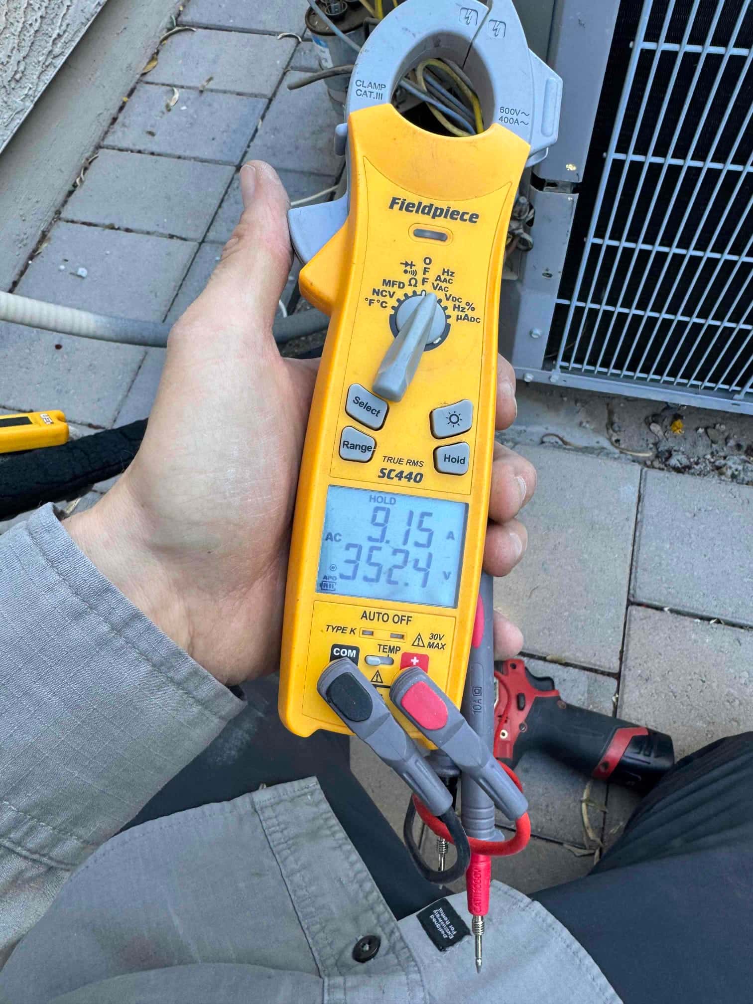 HVAC diagnostic instrument photographed during the service visit.