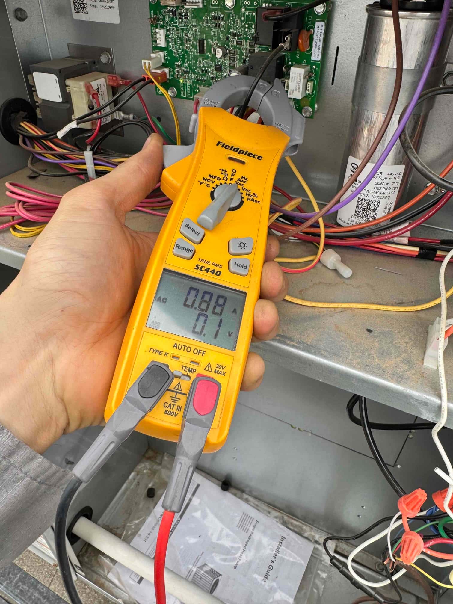 HVAC diagnostic instrument photographed during the service visit.