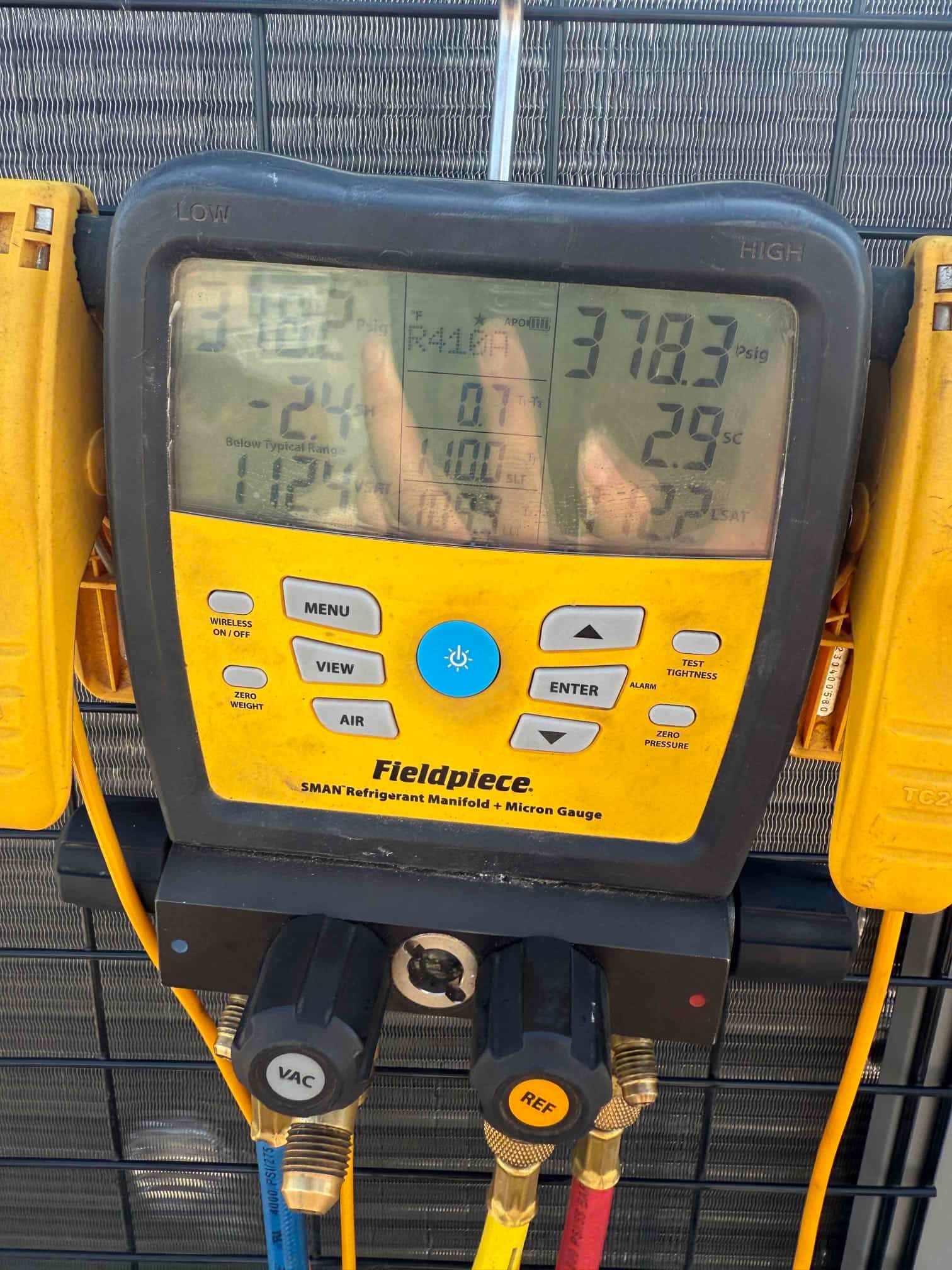 HVAC diagnostic instrument photographed during the service visit.