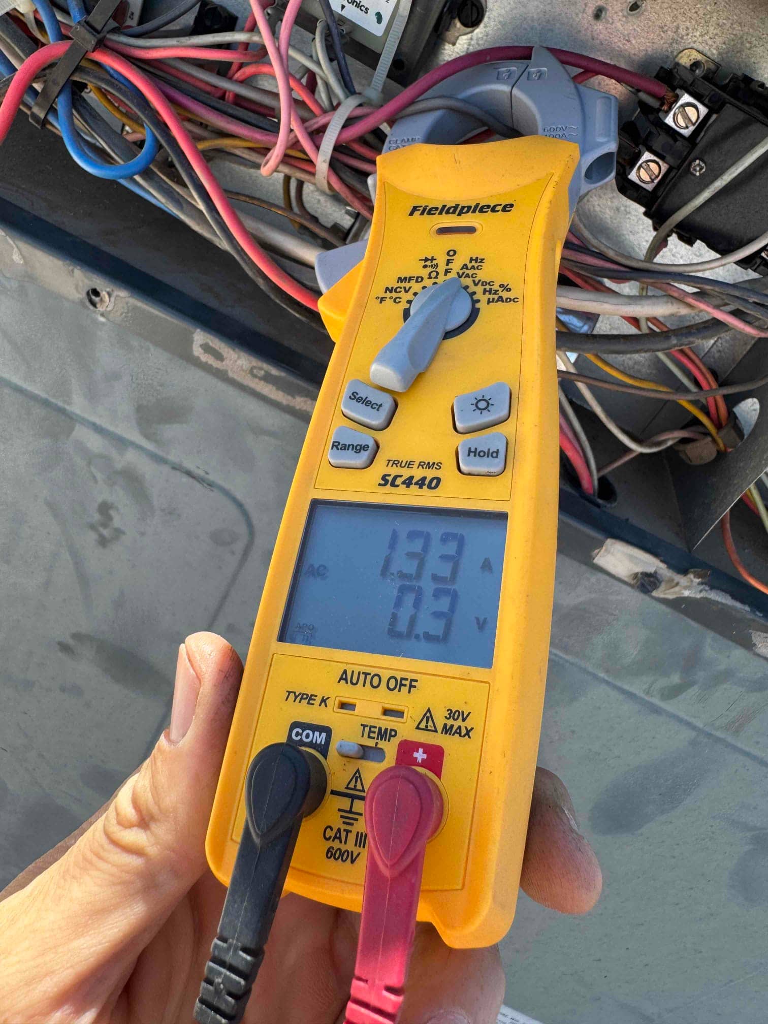 HVAC diagnostic instrument photographed during the service visit.