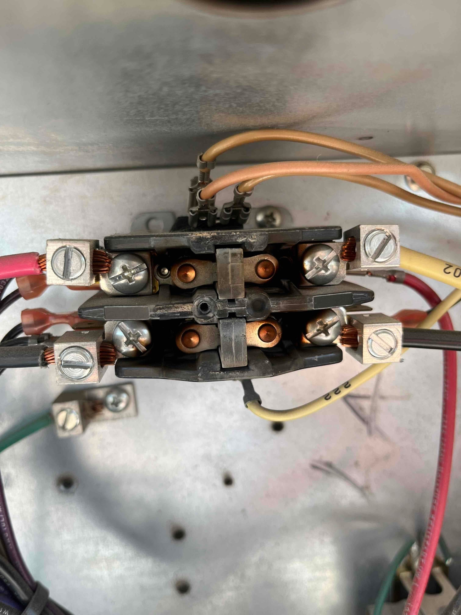Two-pole contactor inside the unit, with tan coil leads and multiple line and load wires secured under screw terminals.