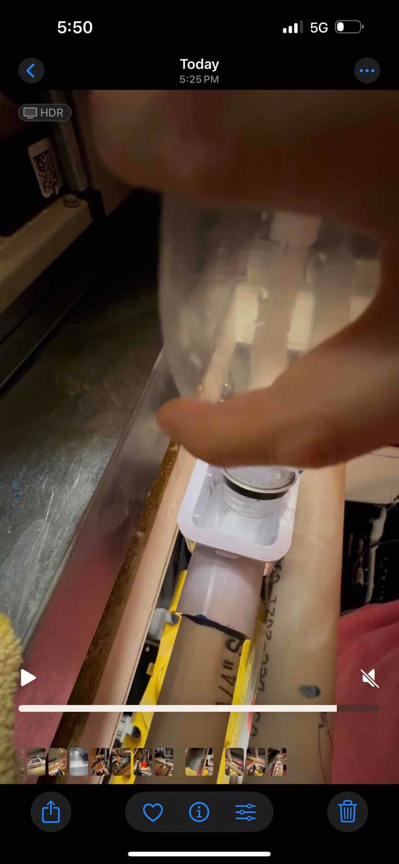 PVC condensate drain line inside the air handler compartment, showing a cleanout fitting with a removable clear cap.