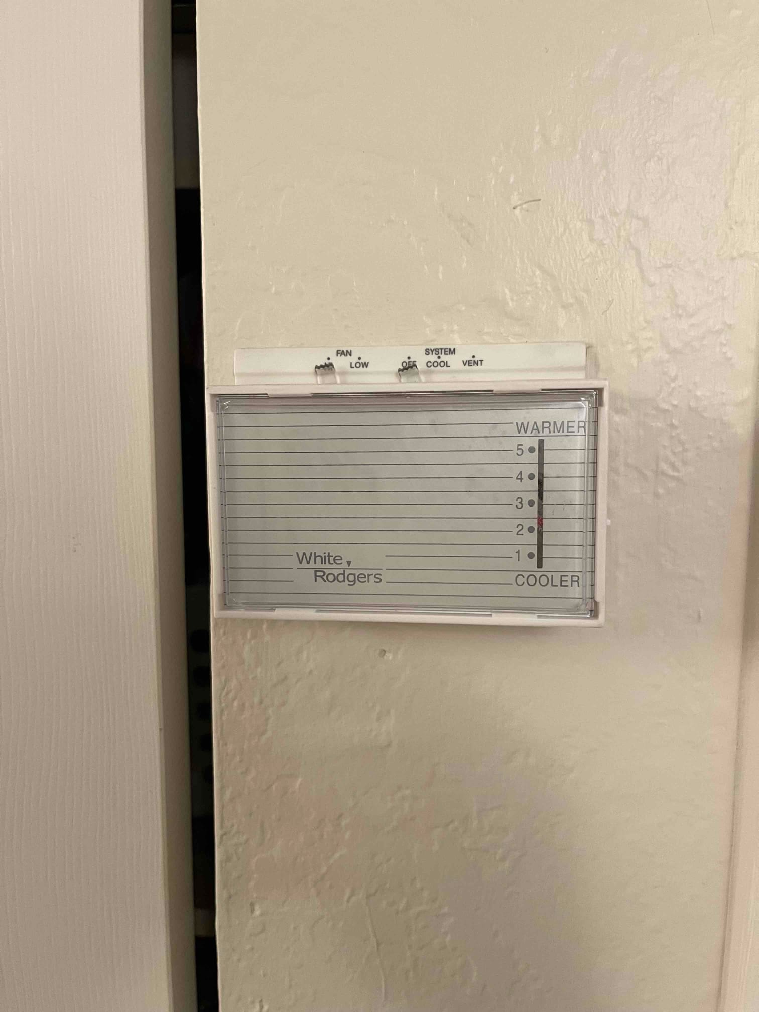 Refrigerant scale photographed during the service visit; no numerical reading is transcribed.
