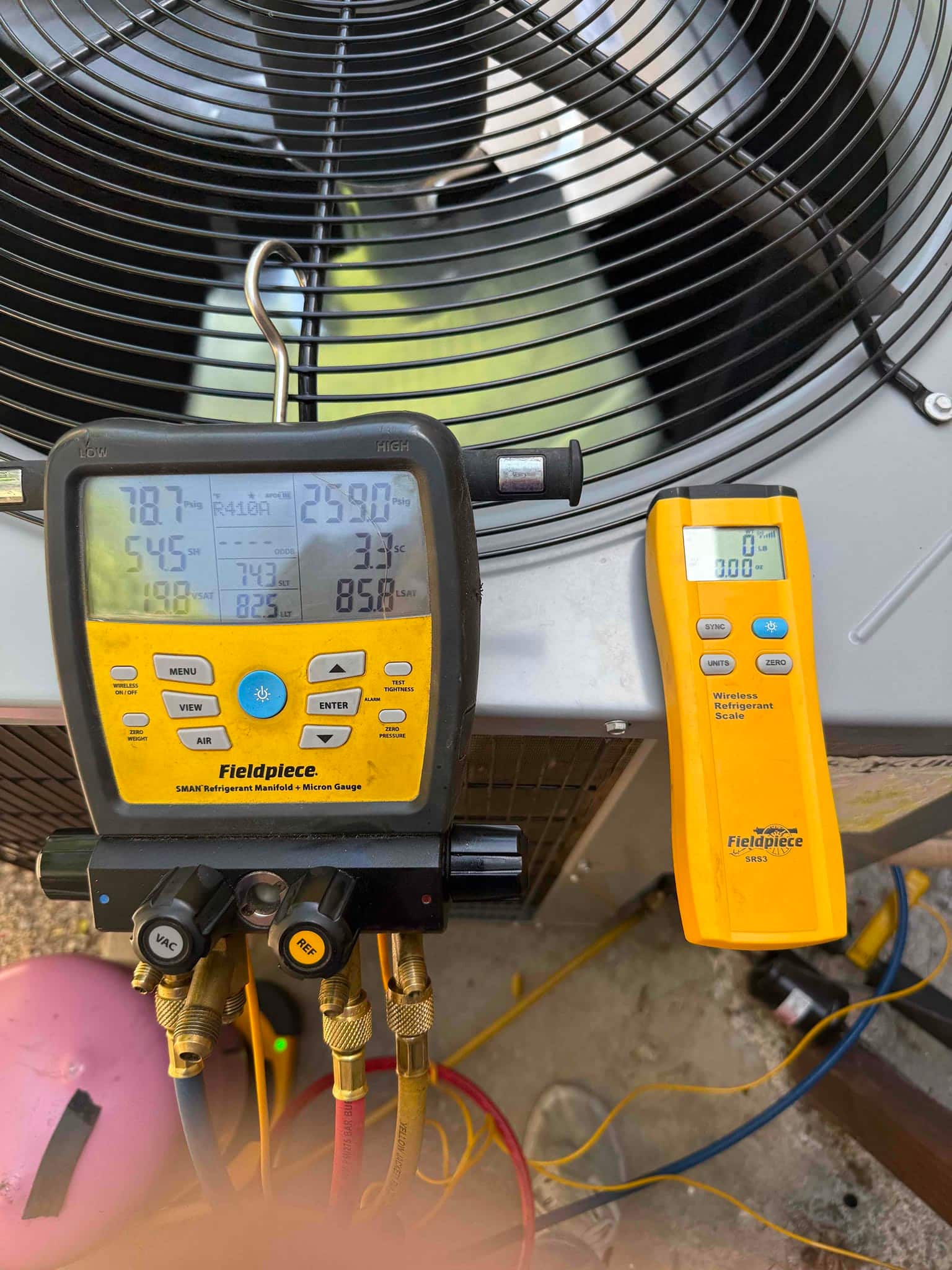 Refrigerant scale photographed during the service visit; no numerical reading is transcribed.