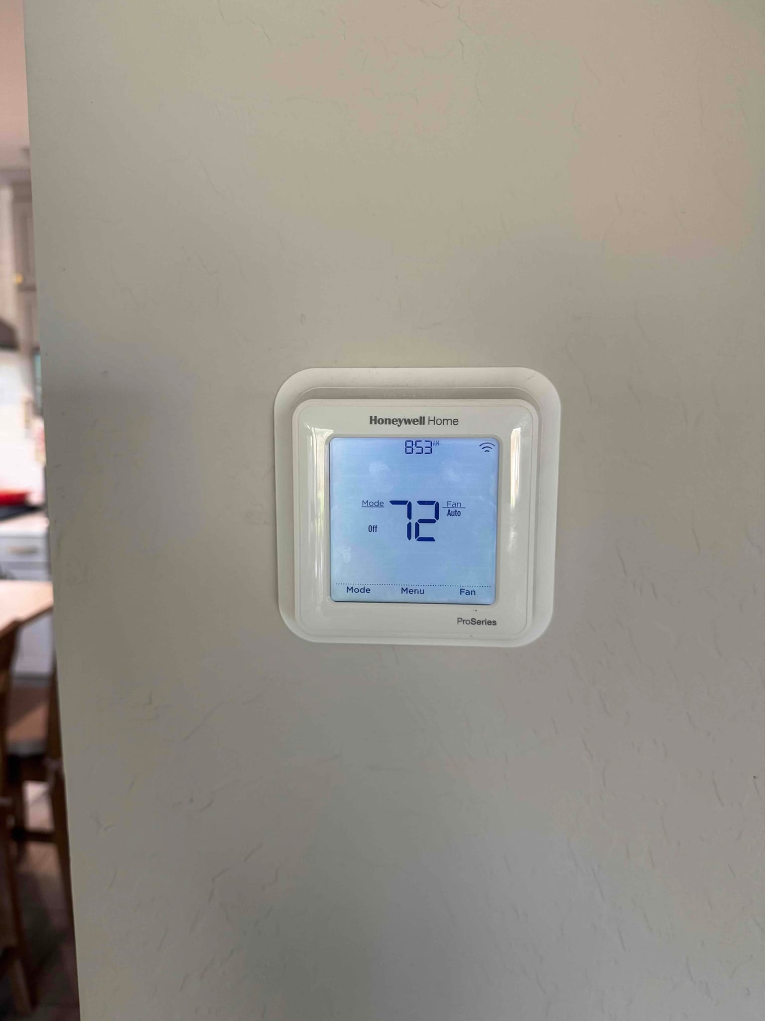 Wall-mounted digital thermostat displays 72°F with system mode Off and fan set to Auto at 8:53.