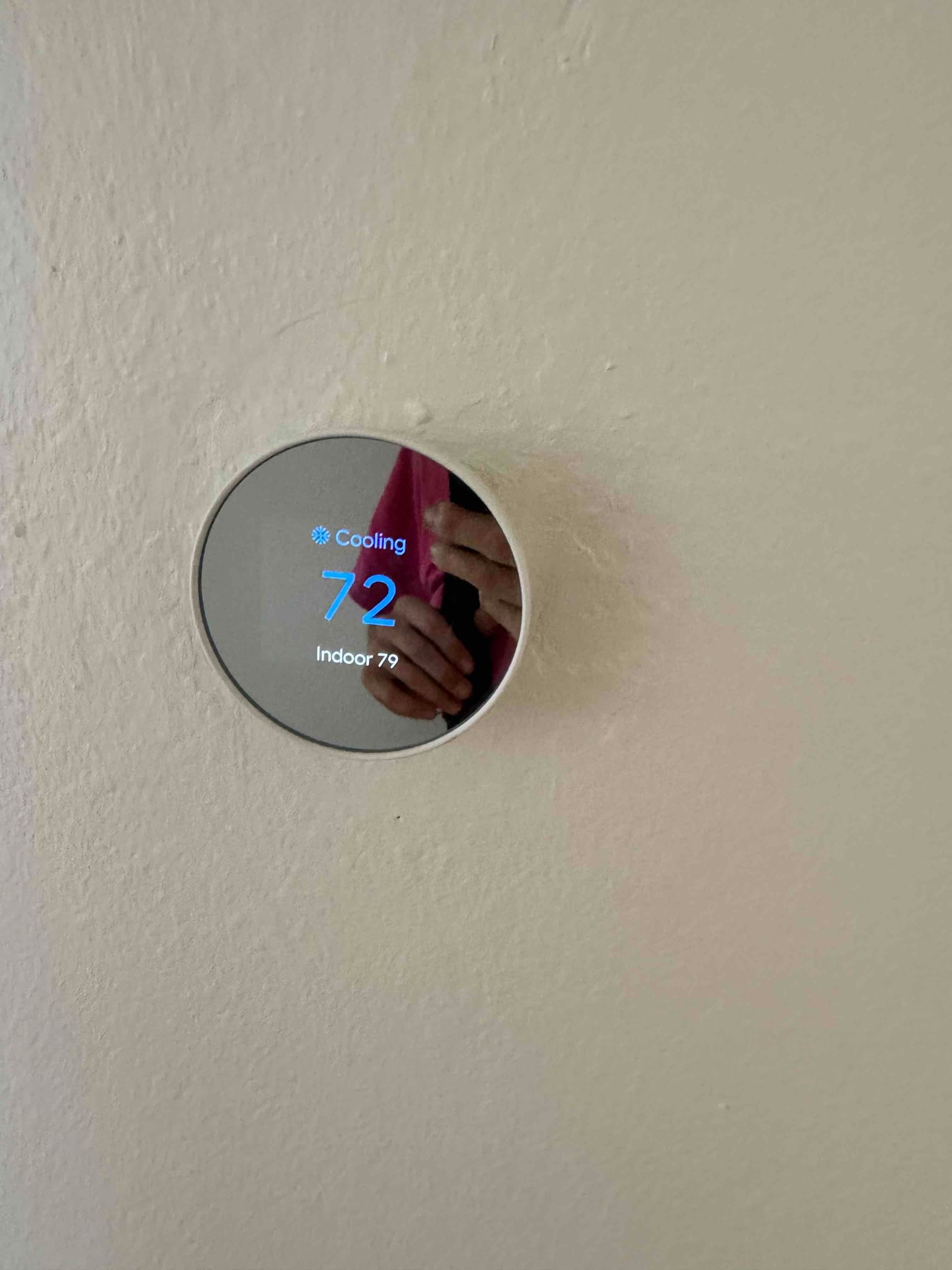 Wall-mounted smart thermostat displays Cooling mode, set to 72, with indoor temperature reading 79.