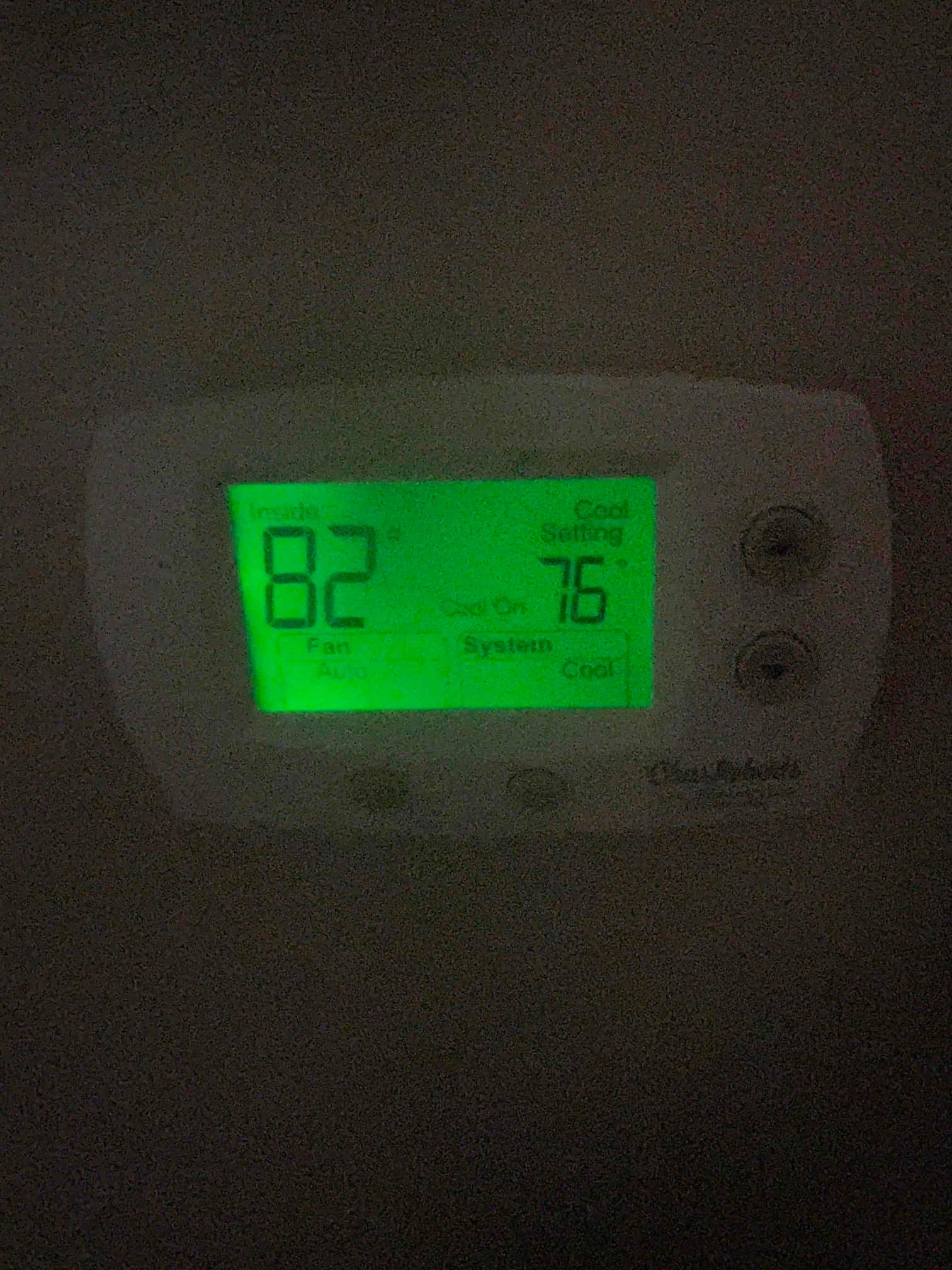 Wall-mounted thermostat display shows indoor temperature 82°F and cooling setpoint 76°F with fan set to Auto.