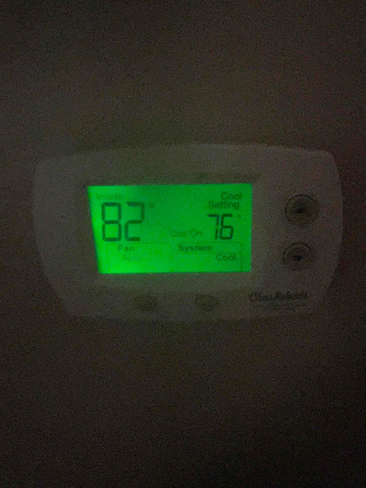 Wall thermostat display shows inside 82°F, cooling set to 76°F, fan on Auto, system in Cool mode.
