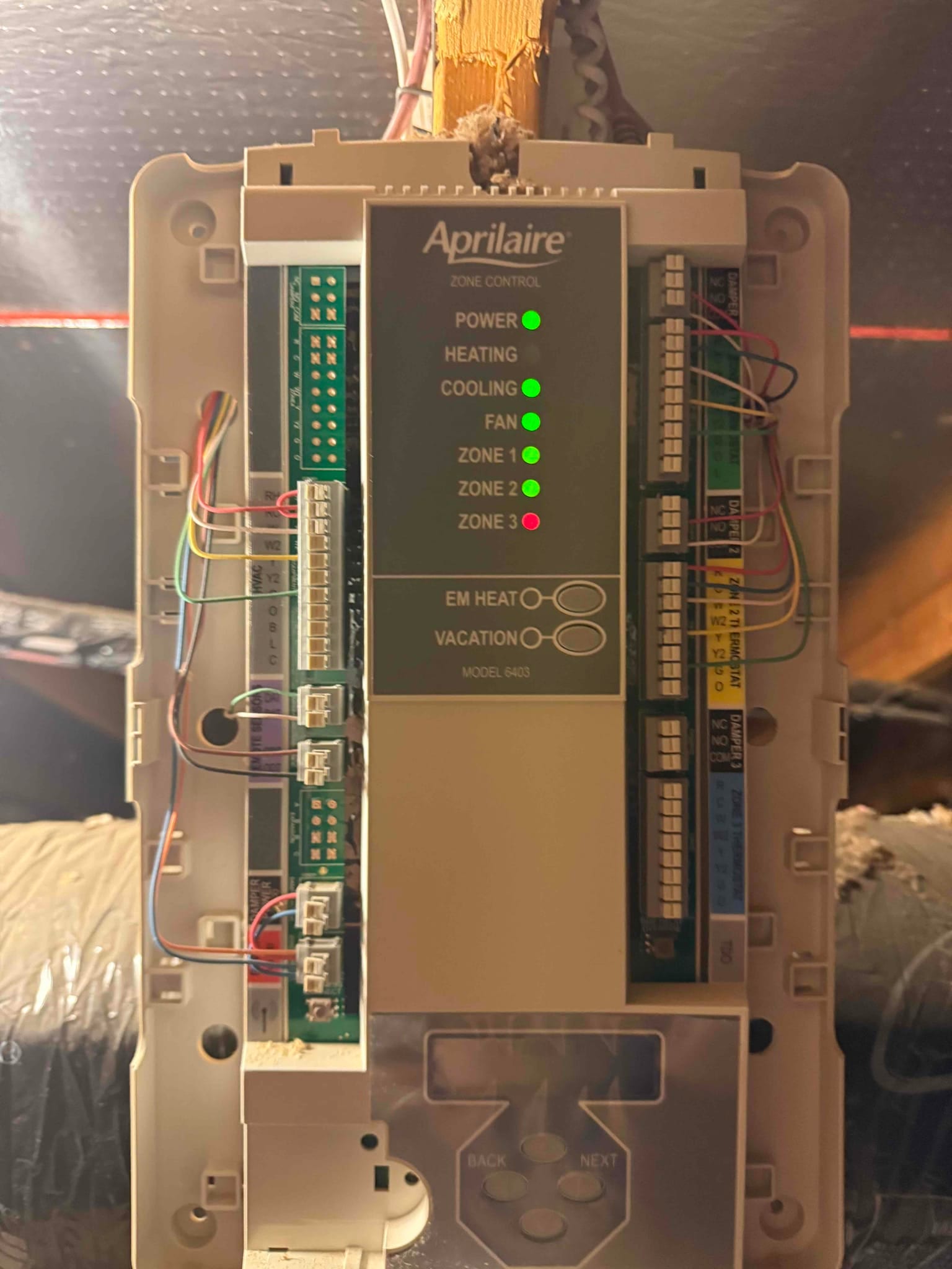 Zone control panel with wiring connected on both sides and multiple green status LEDs illuminated for power, fan, cooling, and zones.