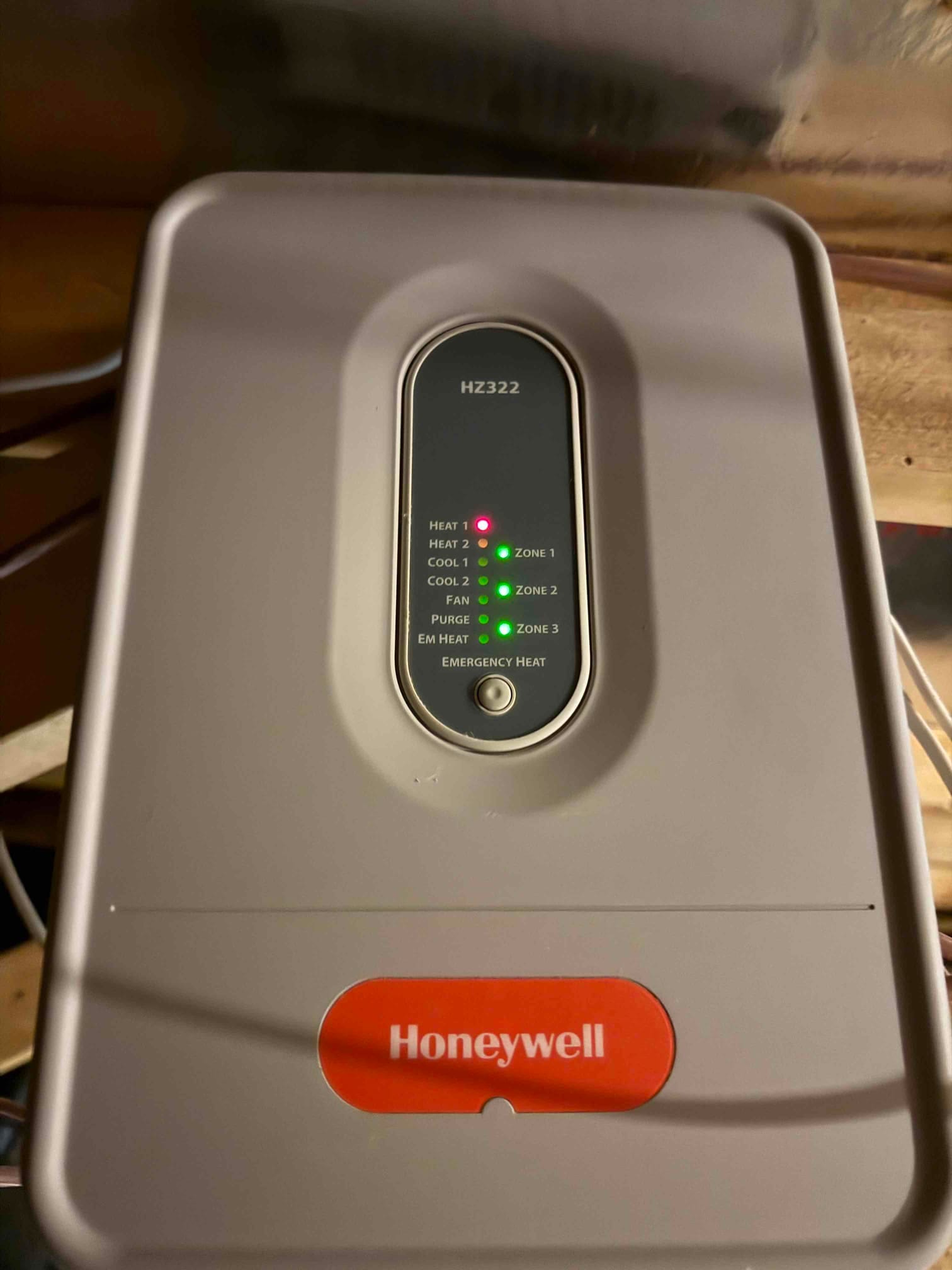 Zoning control panel with indicator lights on for Heat 1, Emergency Heat, and Zones 1–3.