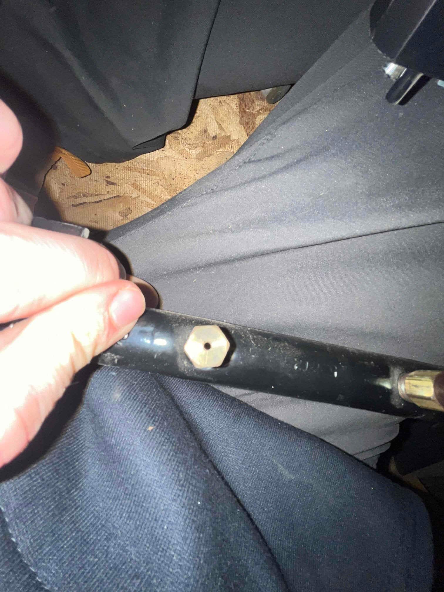 Black hose section shows a small brass hex fitting with a centered hole.