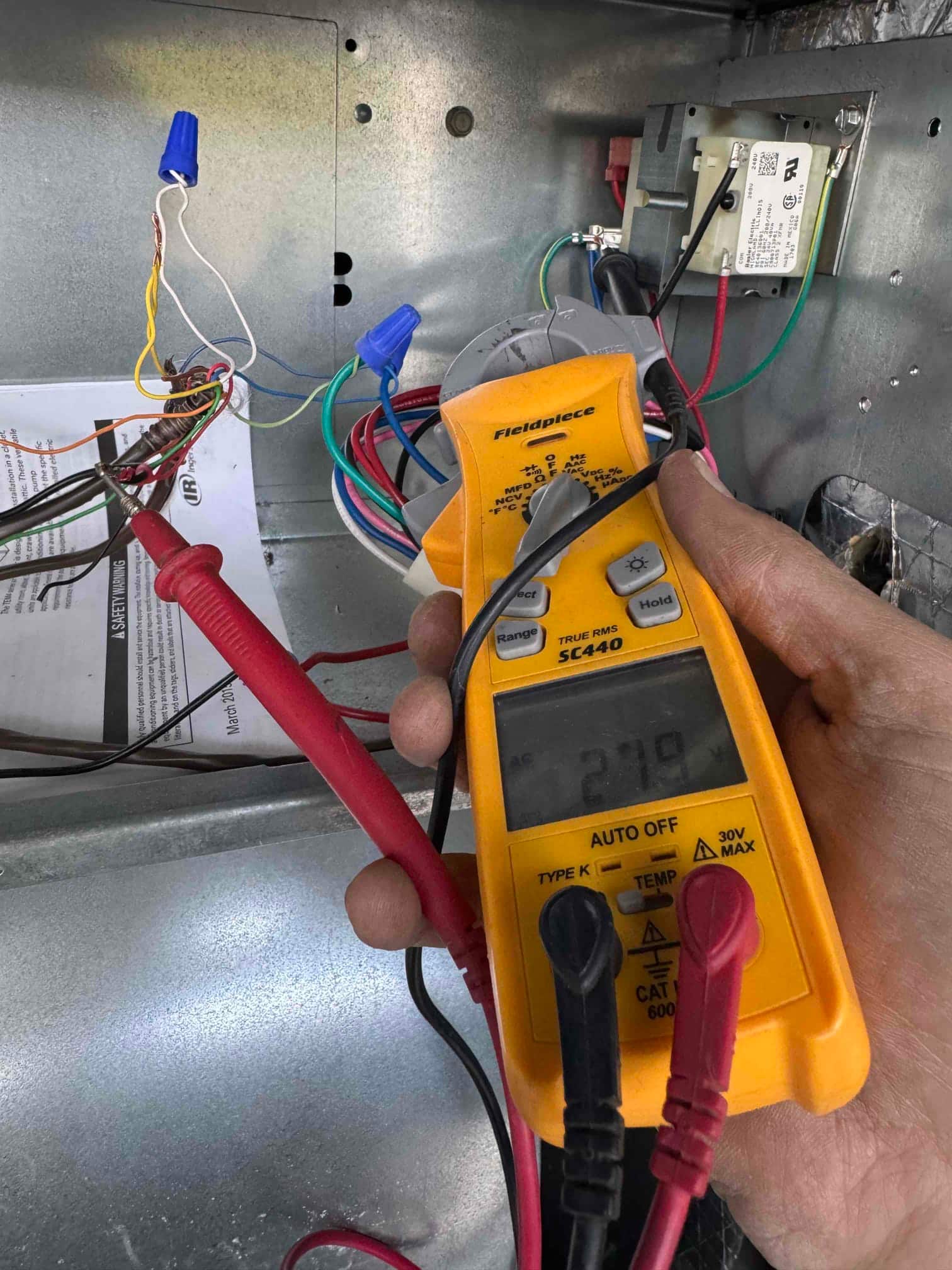 Diagnostic instrument display shows 21.9 V.