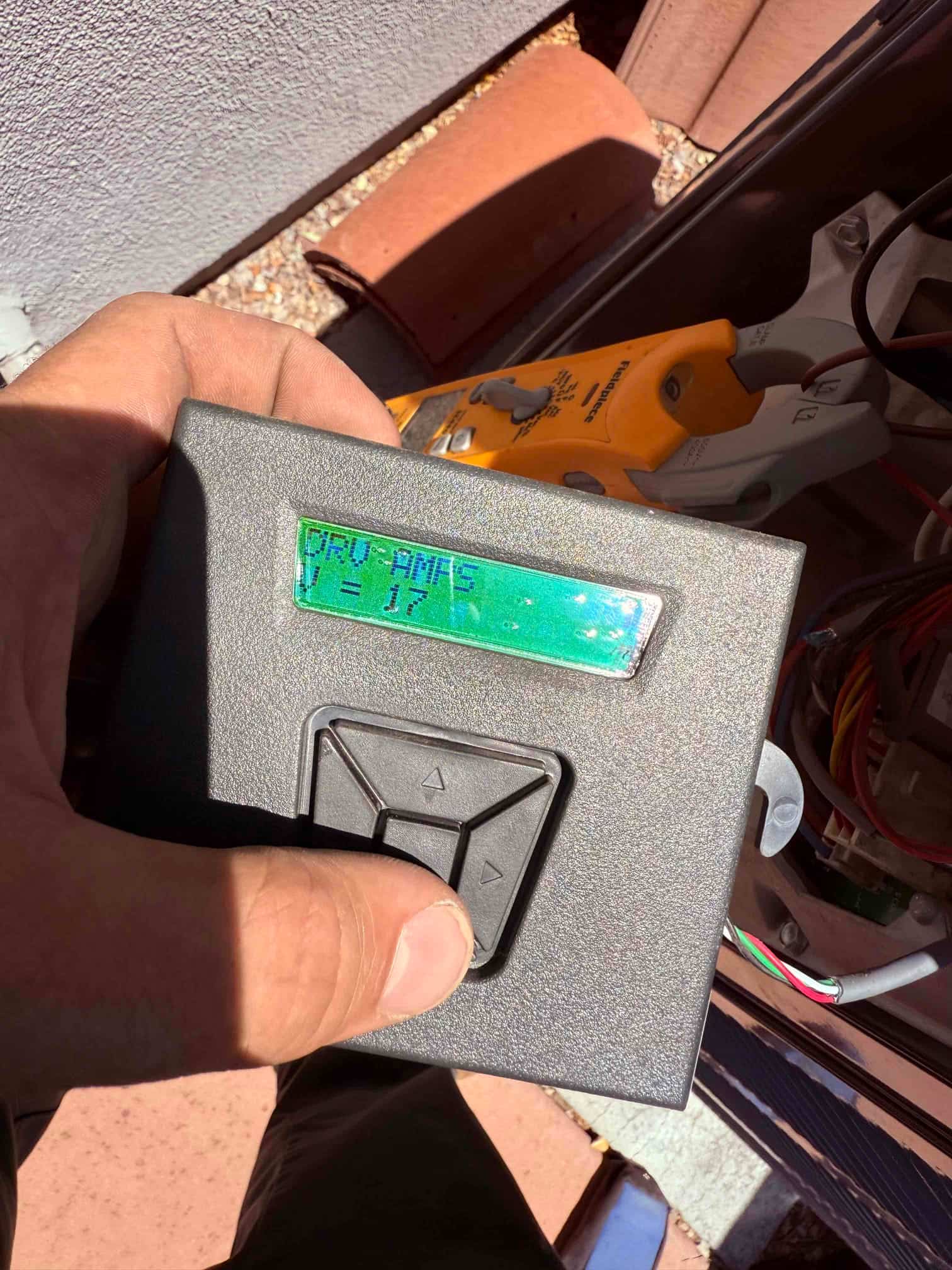 HVAC diagnostic instrument photographed during the service visit.