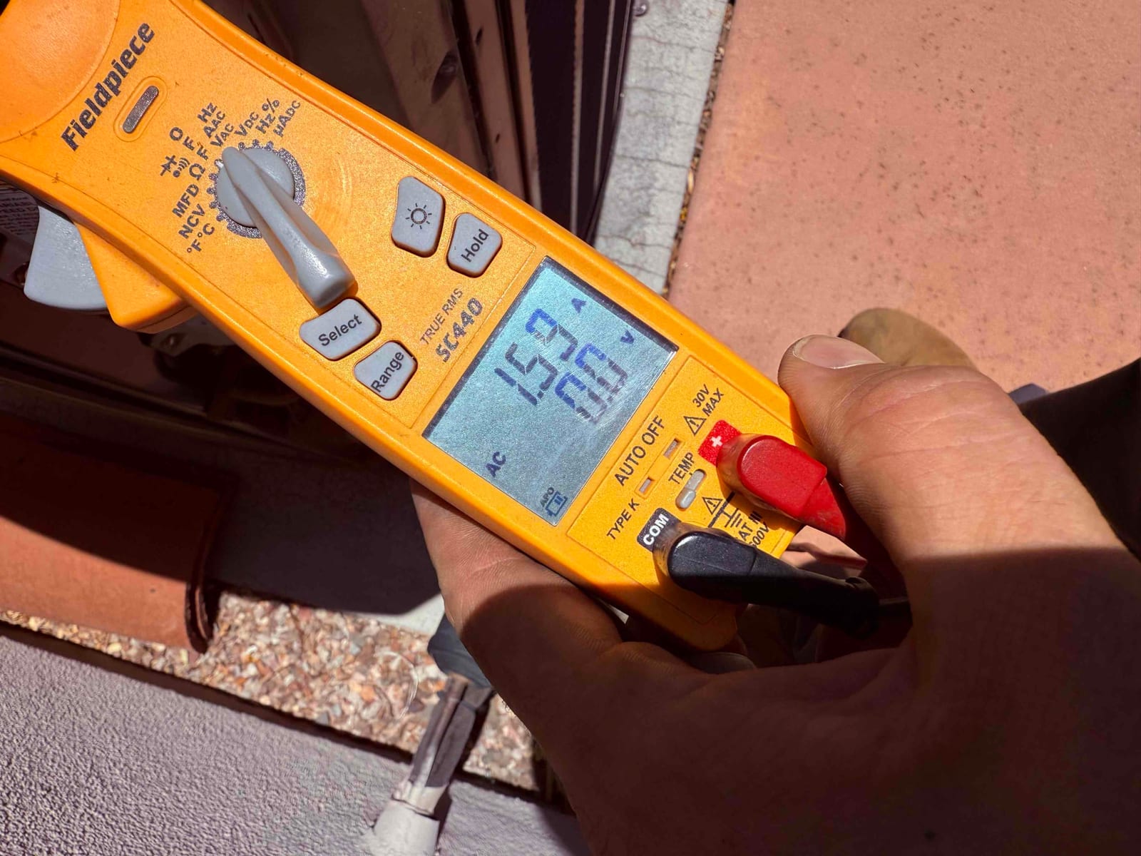 HVAC diagnostic instrument photographed during the service visit.