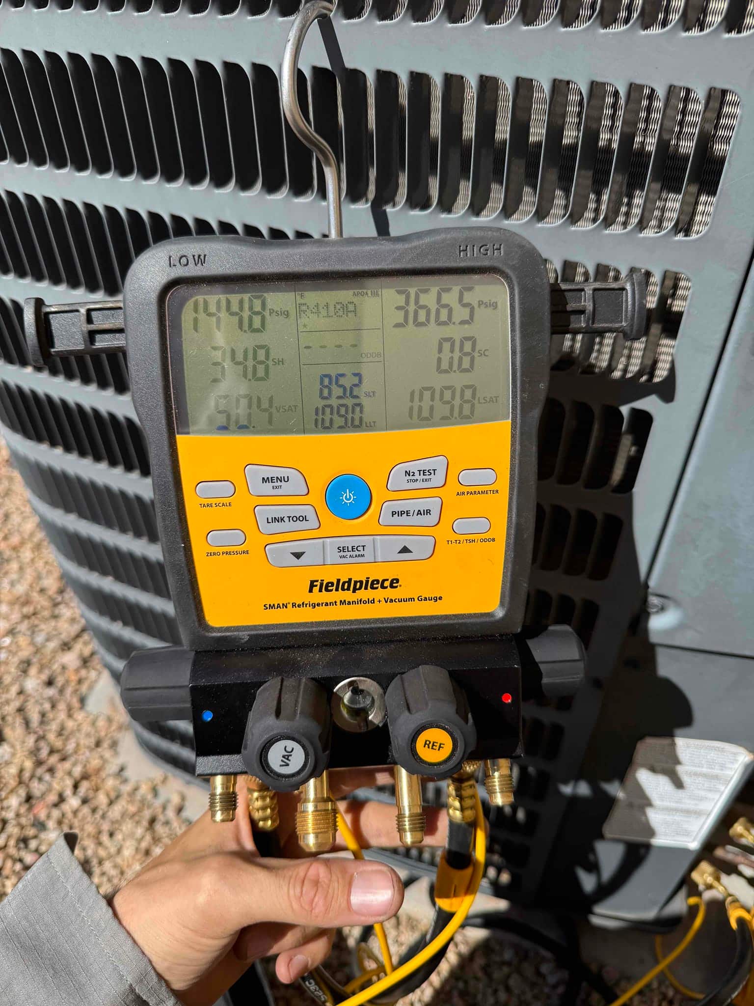 HVAC diagnostic instrument photographed during the service visit.