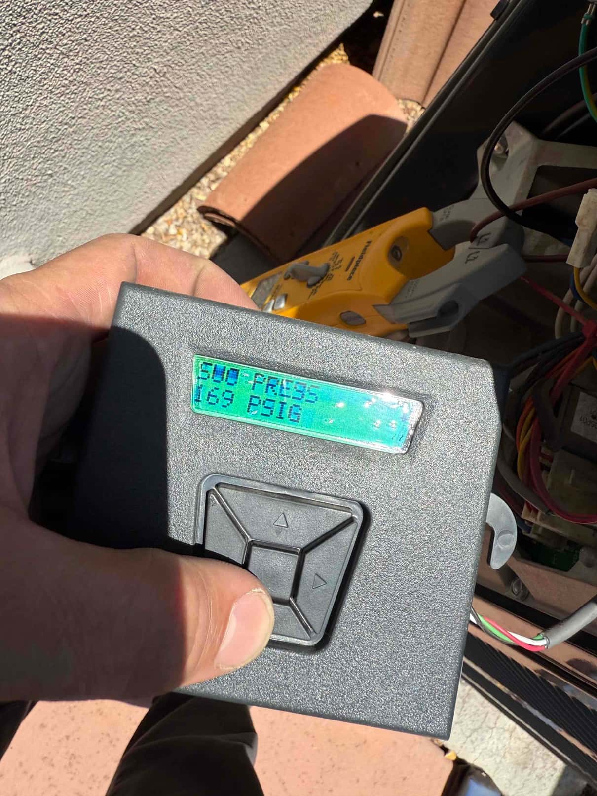 HVAC diagnostic instrument photographed during the service visit.