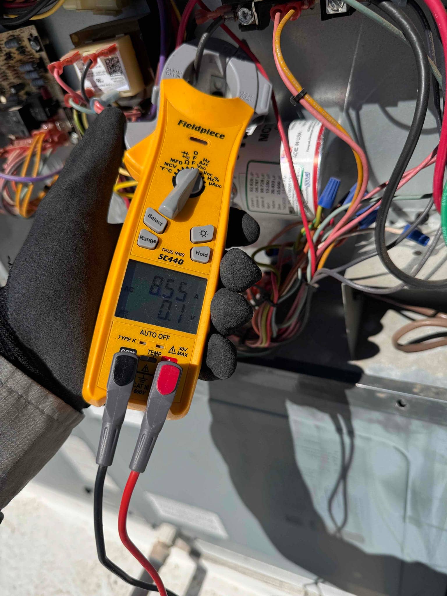 HVAC diagnostic instrument photographed during the service visit.