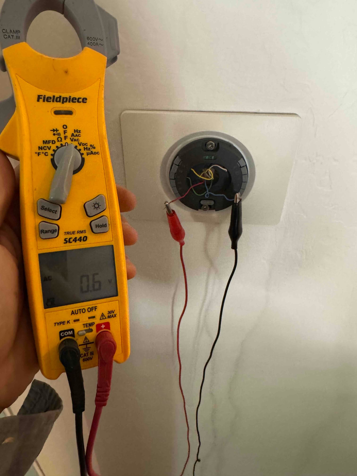 HVAC diagnostic instrument photographed during the service visit.