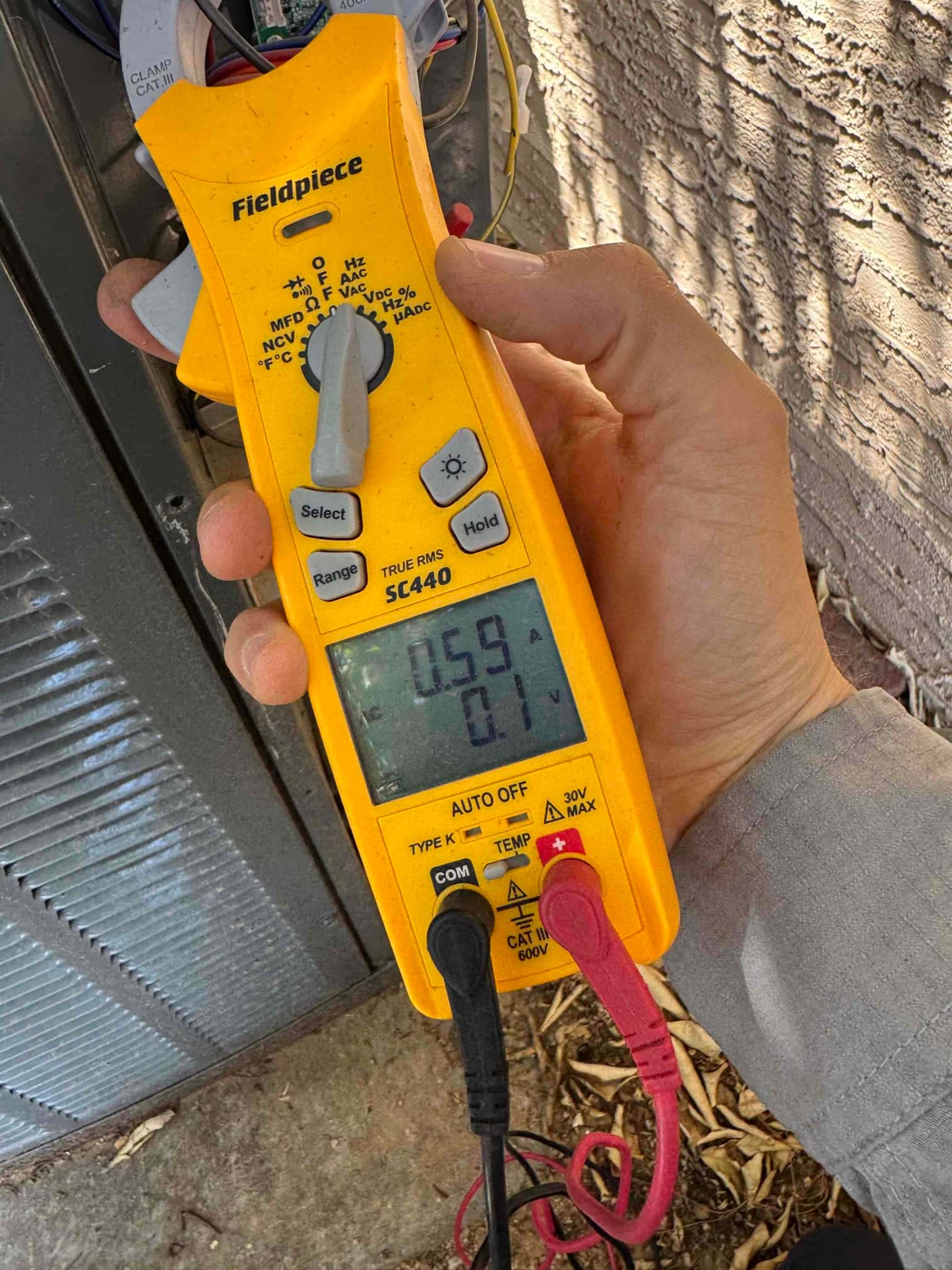HVAC diagnostic instrument photographed during the service visit.