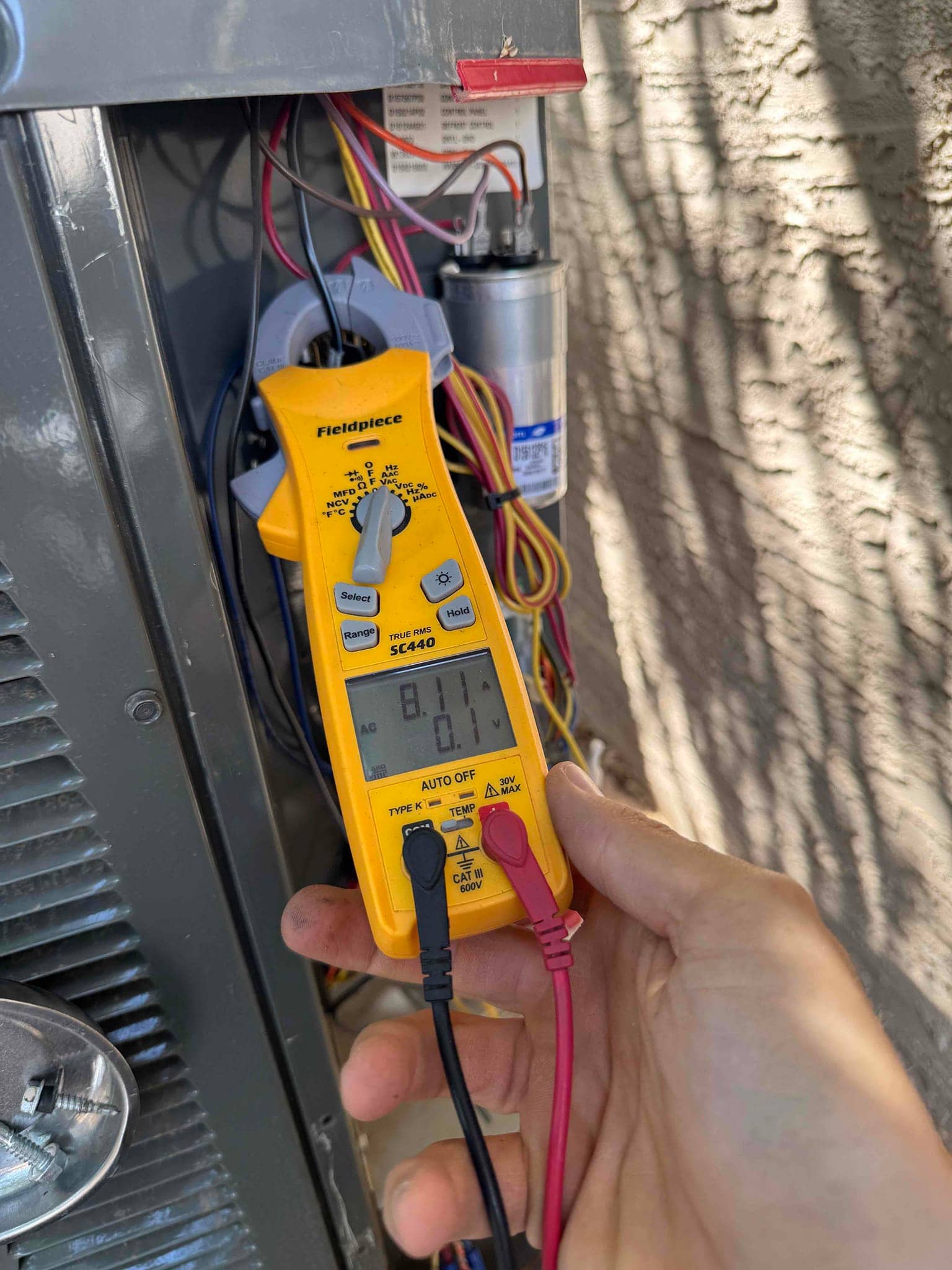 HVAC diagnostic instrument photographed during the service visit.
