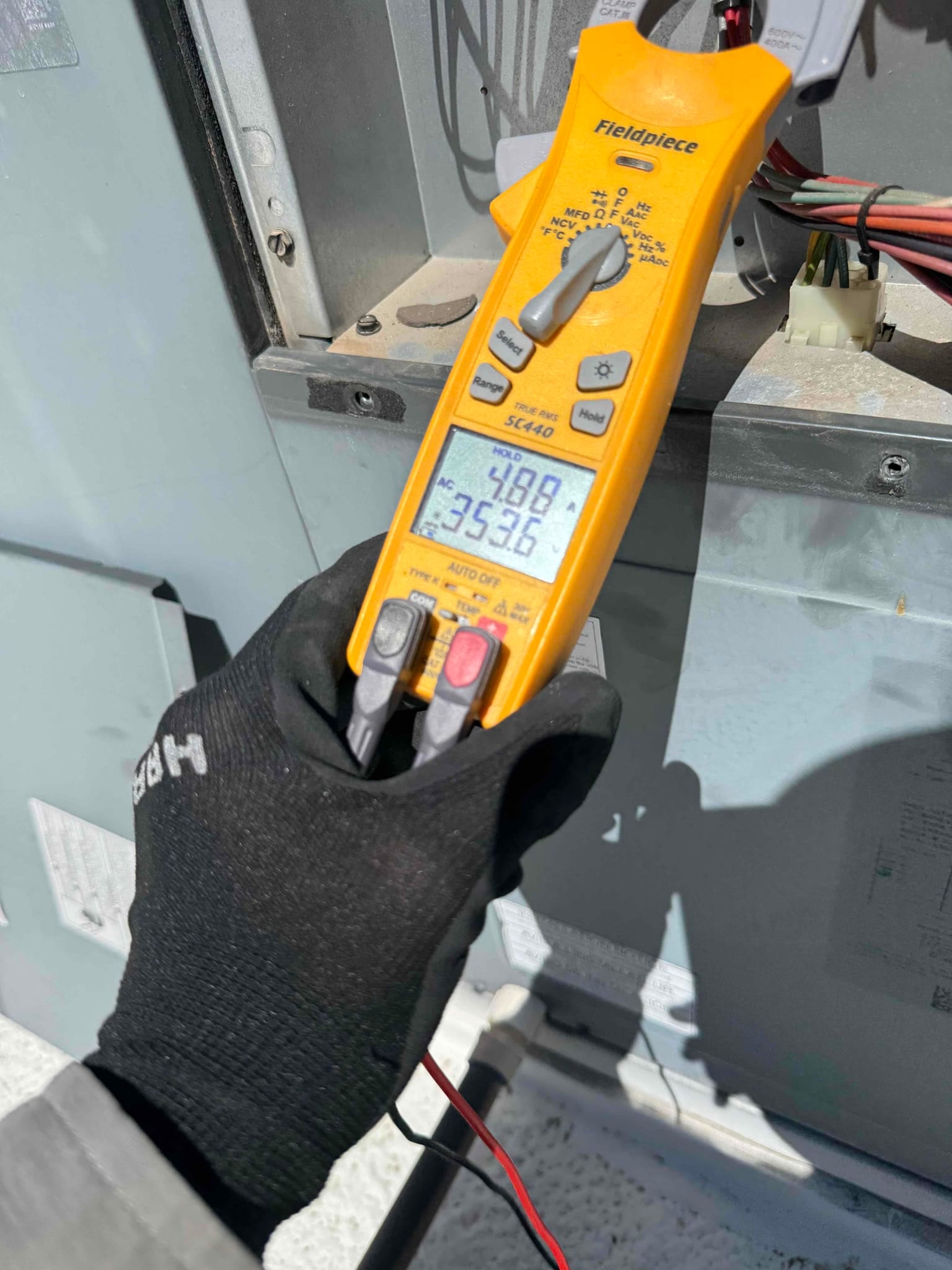 HVAC diagnostic instrument photographed during the service visit.