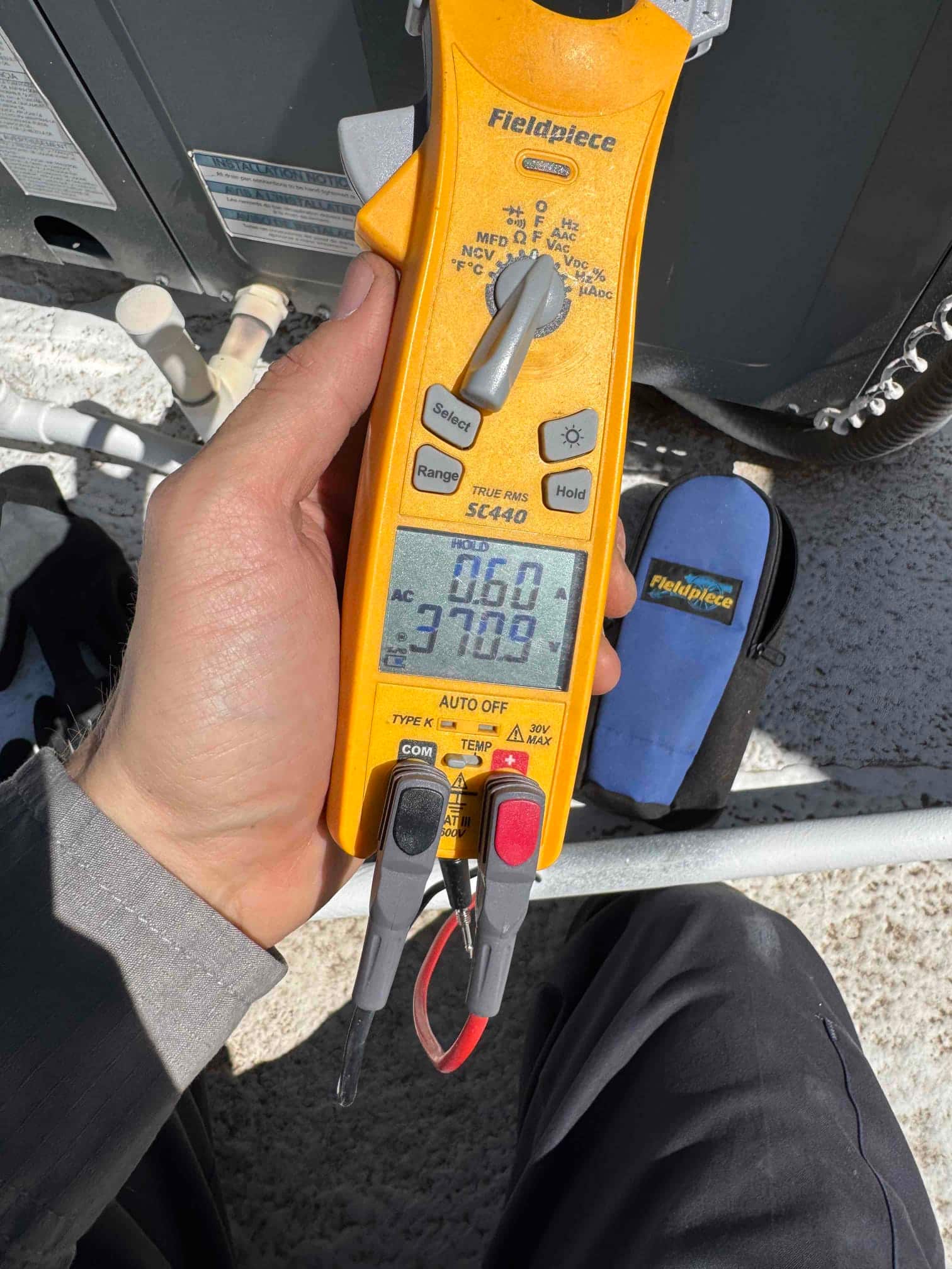 HVAC diagnostic instrument photographed during the service visit.