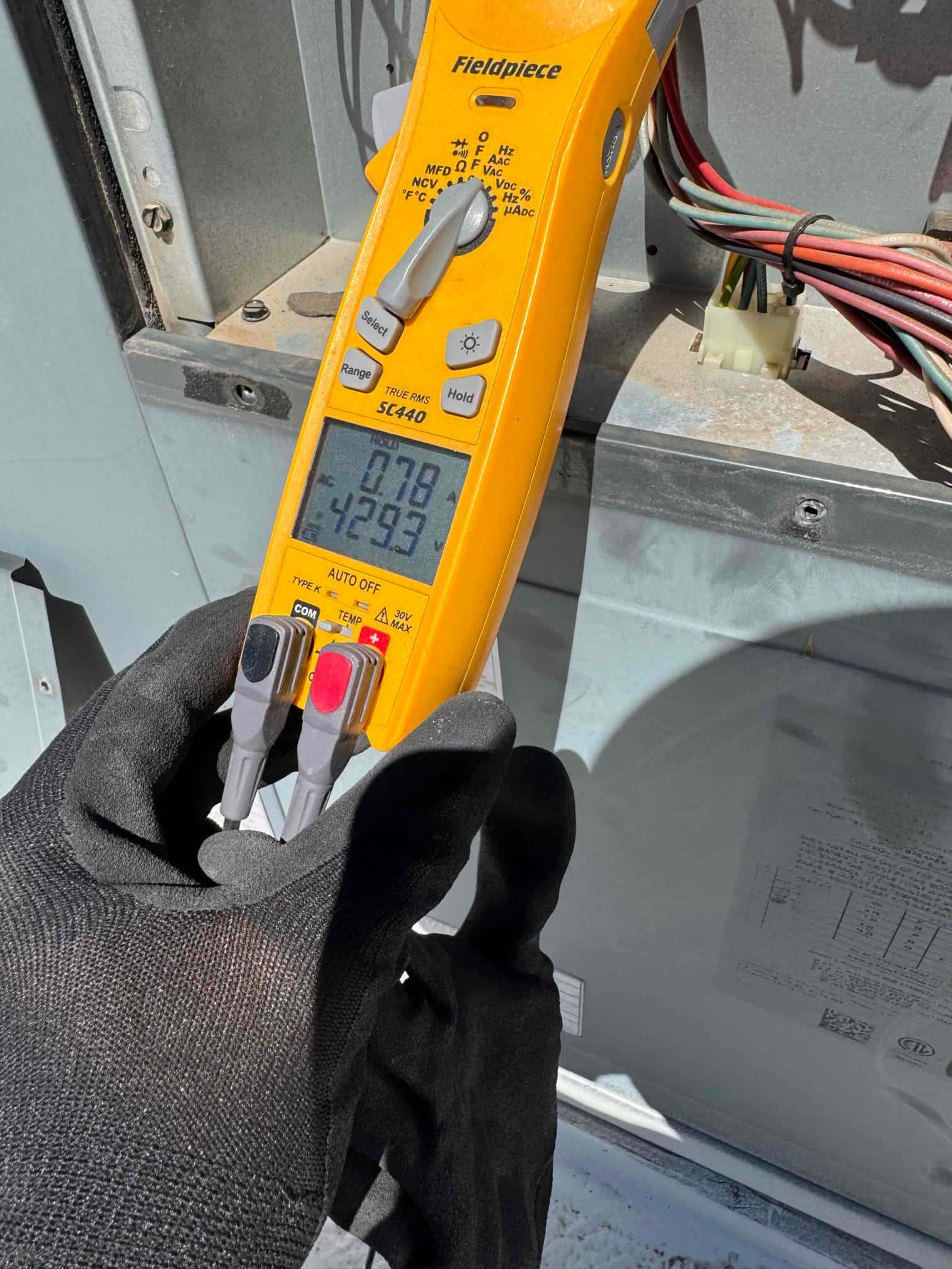 HVAC diagnostic instrument photographed during the service visit.