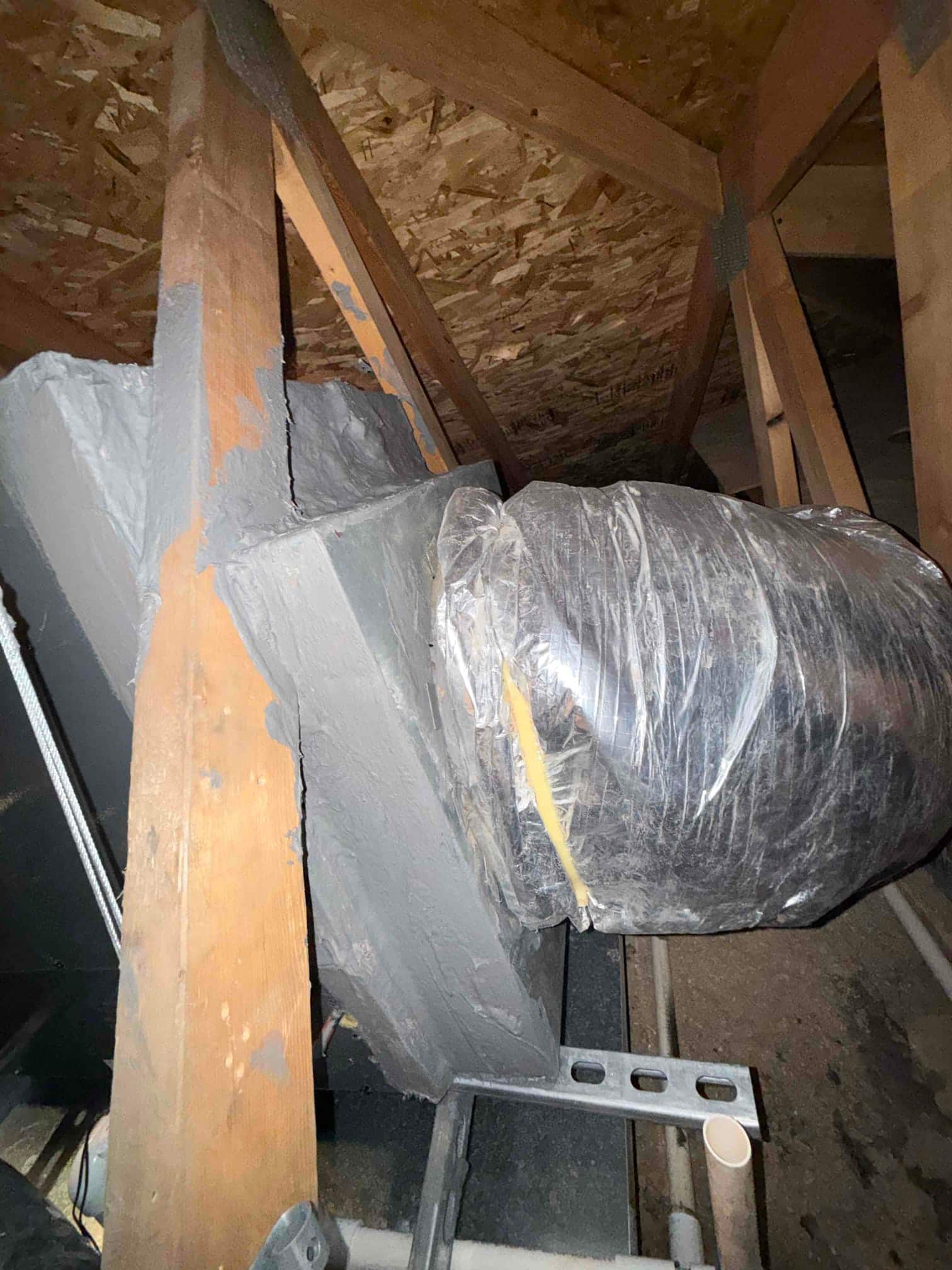Insulated flexible duct connected to a sealed plenum in an attic, with mastic applied around joints.