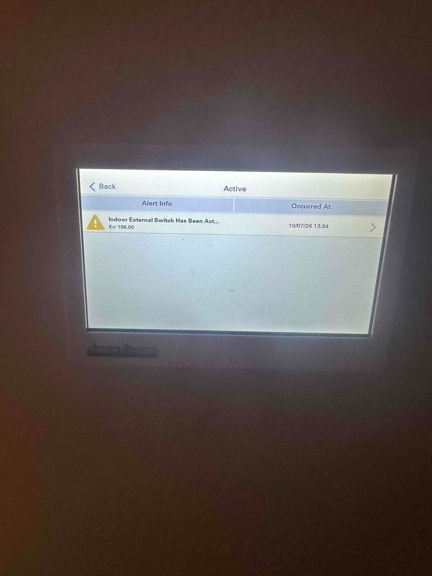 Thermostat touchscreen displays an active alert stating Indoor External Switch has been activated with error code 106.00.